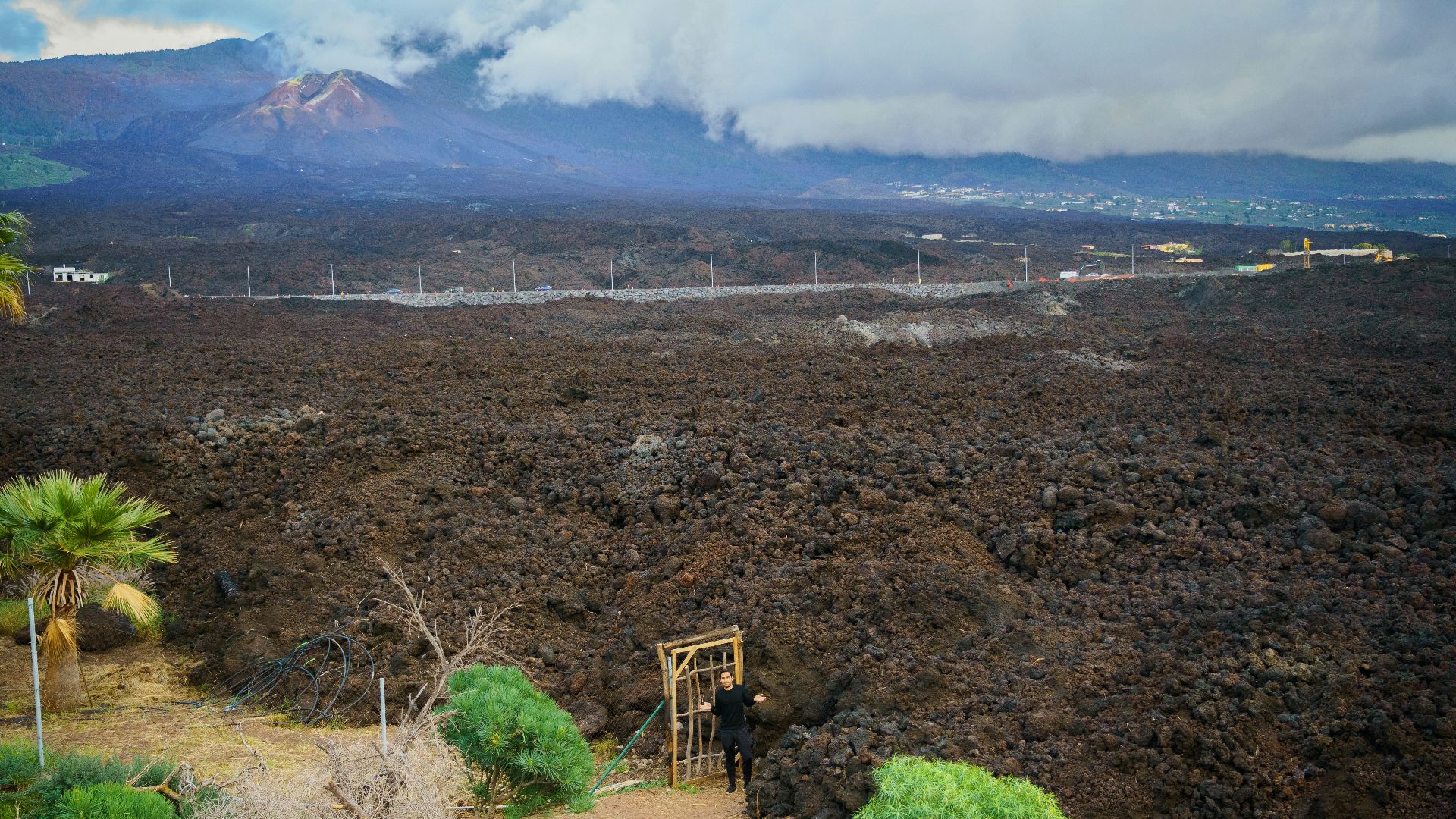 a dirt field with a mountain in the background