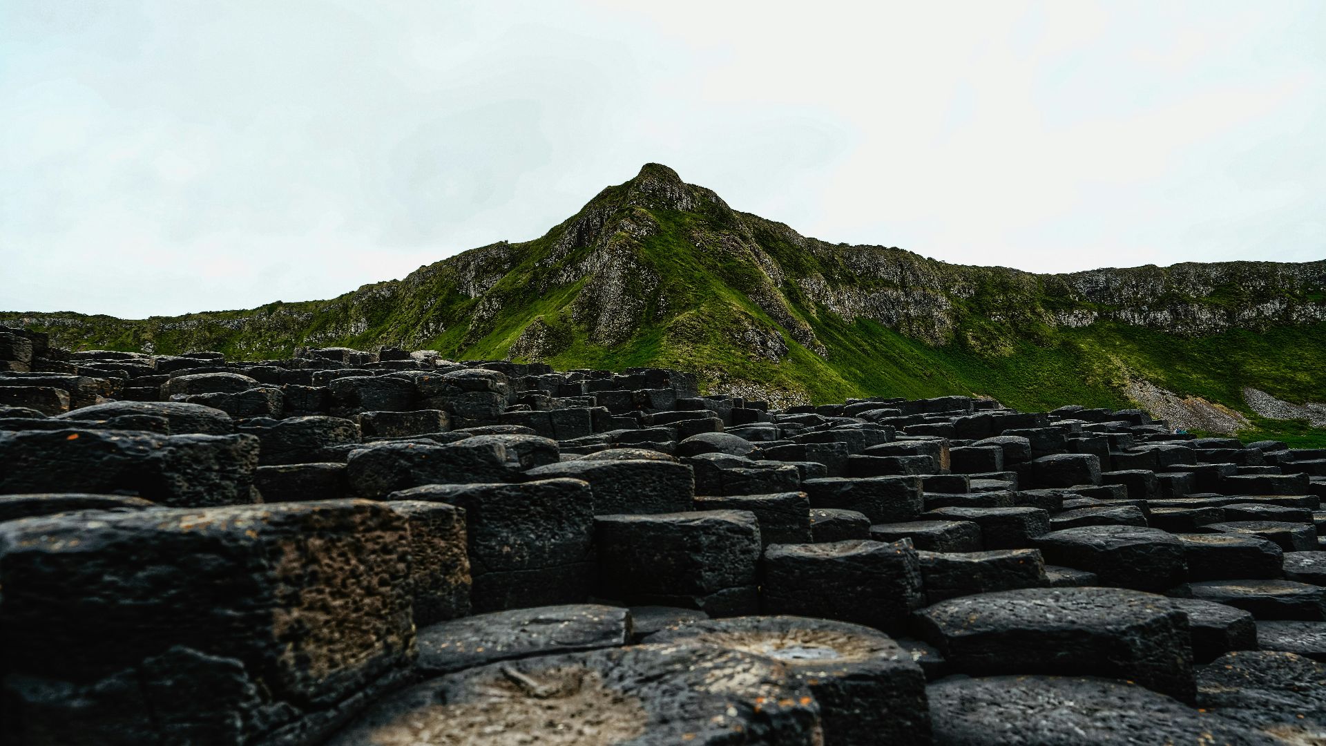 A large group of rocks with a mountain in the background
