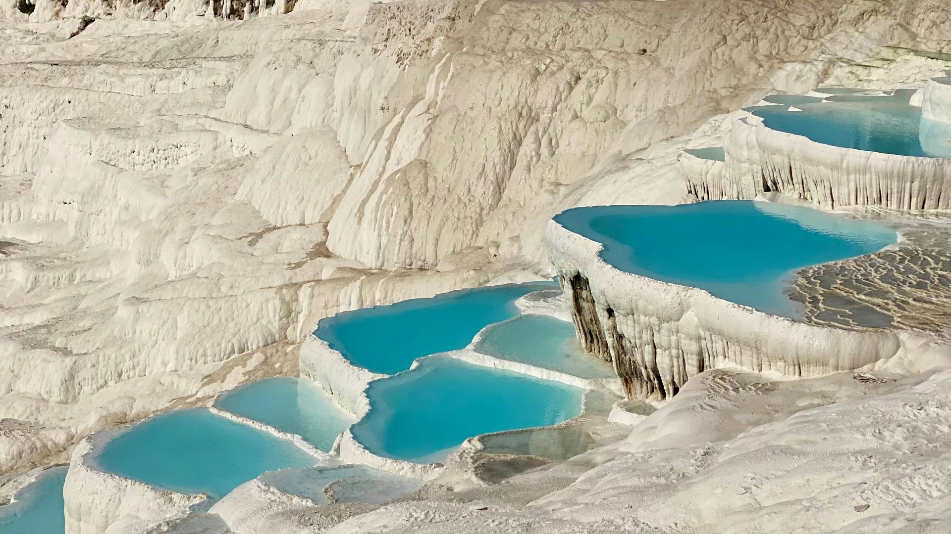 A group of people standing on top of a snow covered slope