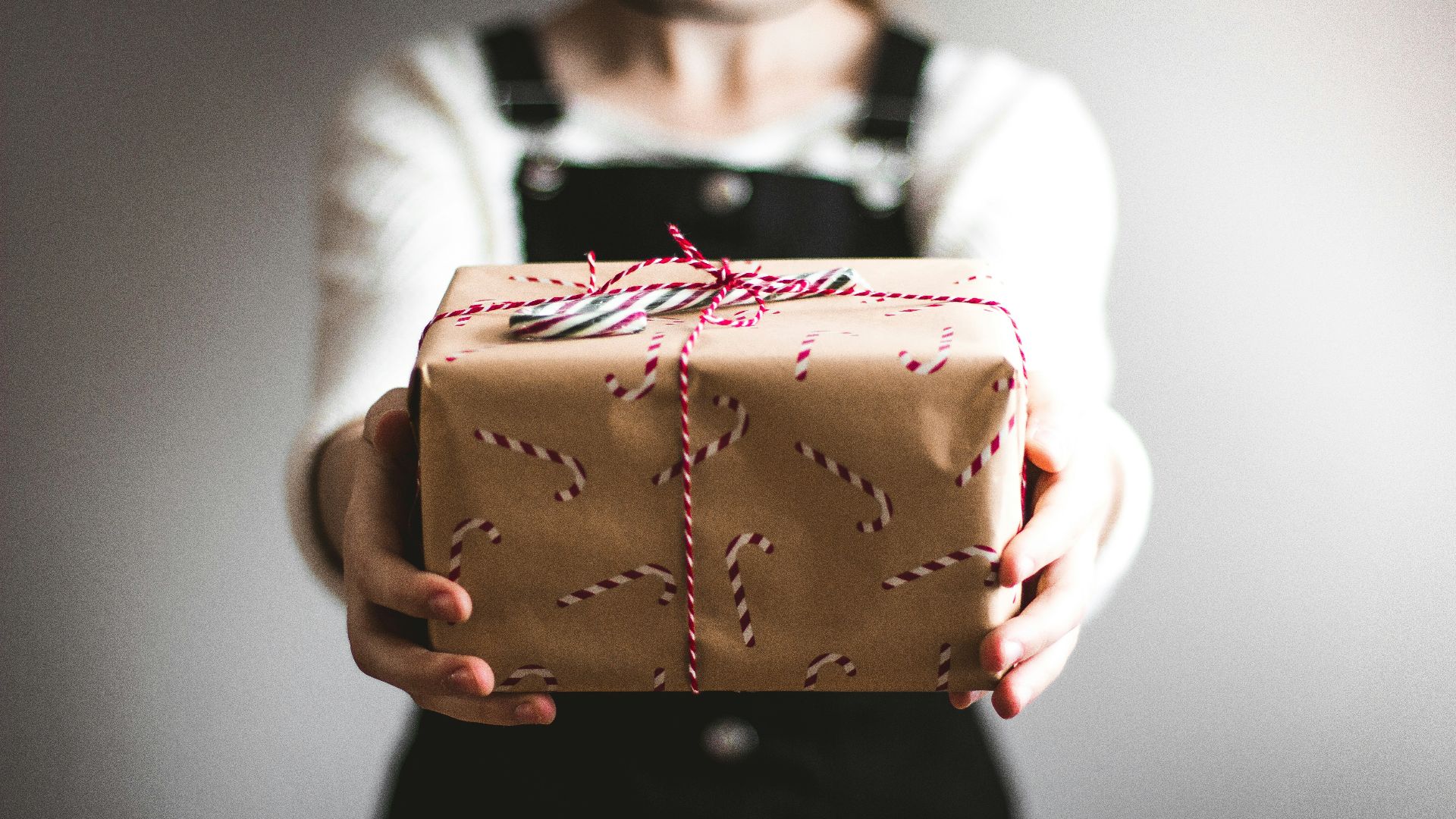person showing brown gift box