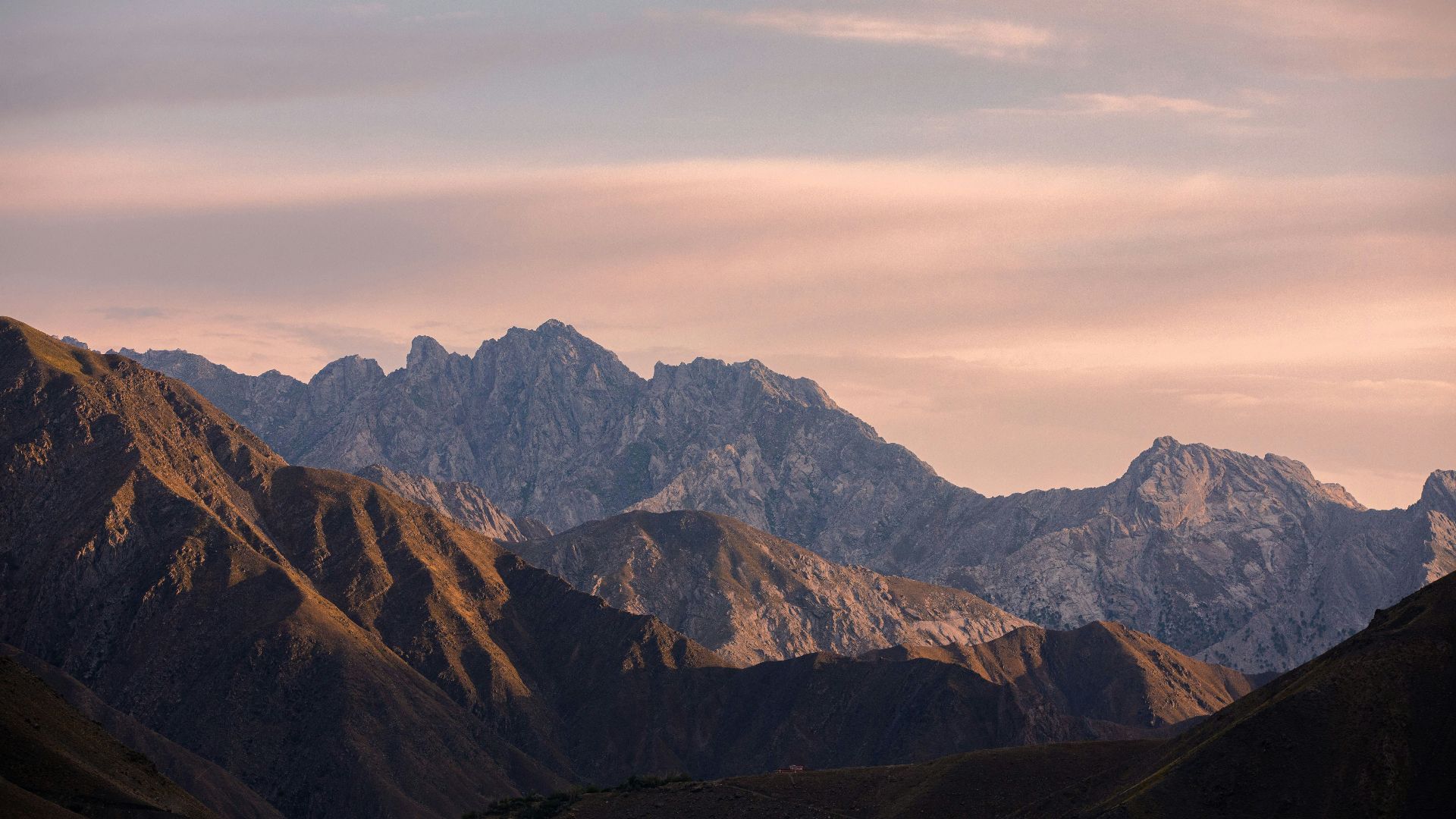 brown and green mountains under white clouds during daytime