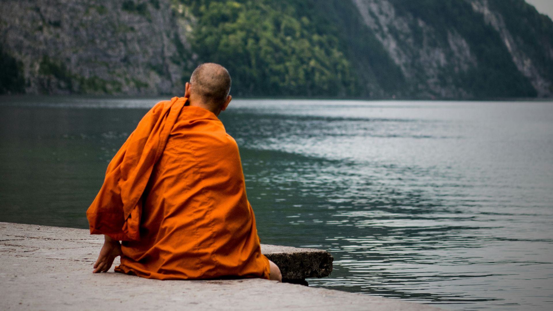 man sitting near ocean