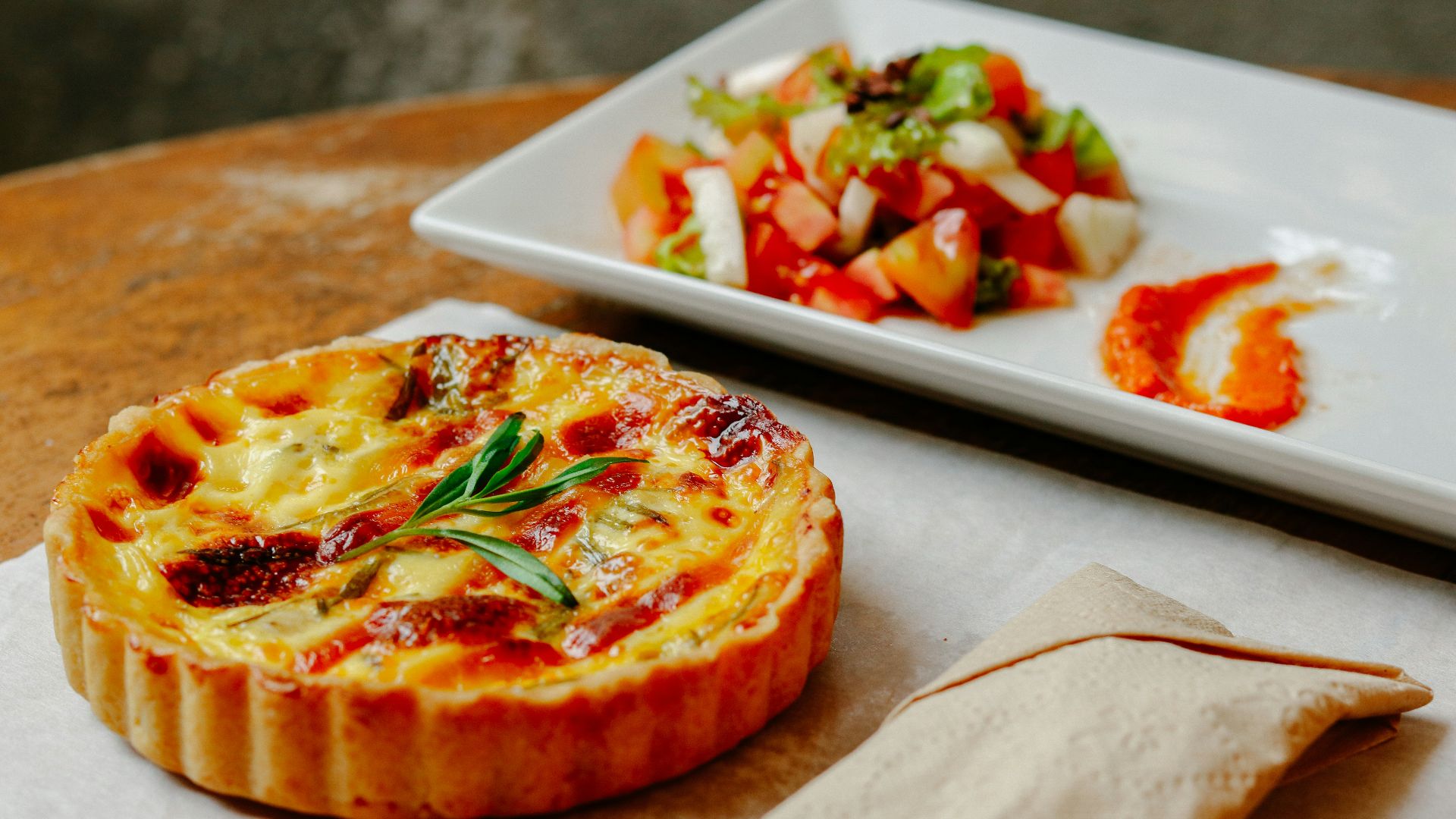 pizza with green leaf on white ceramic tray