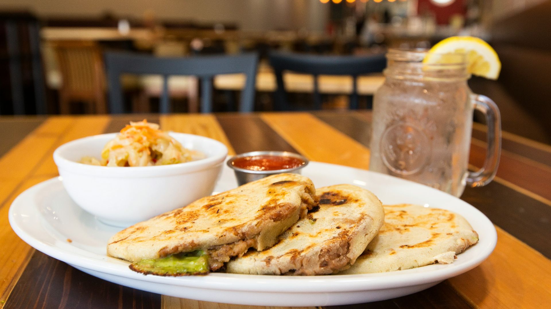 white ceramic plate with food on brown wooden table