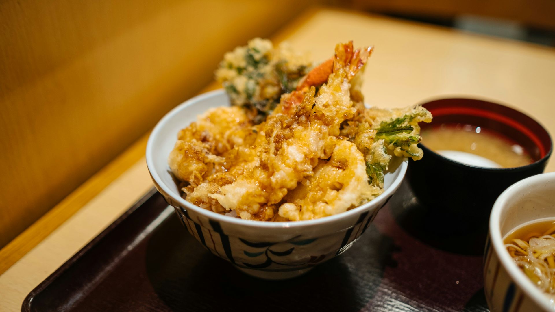 brown rice on white and blue ceramic bowl