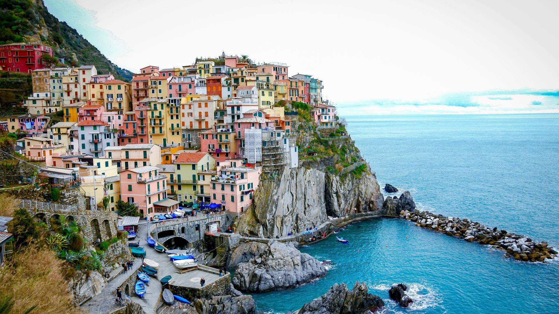 houses on cliff near body of water during daytime