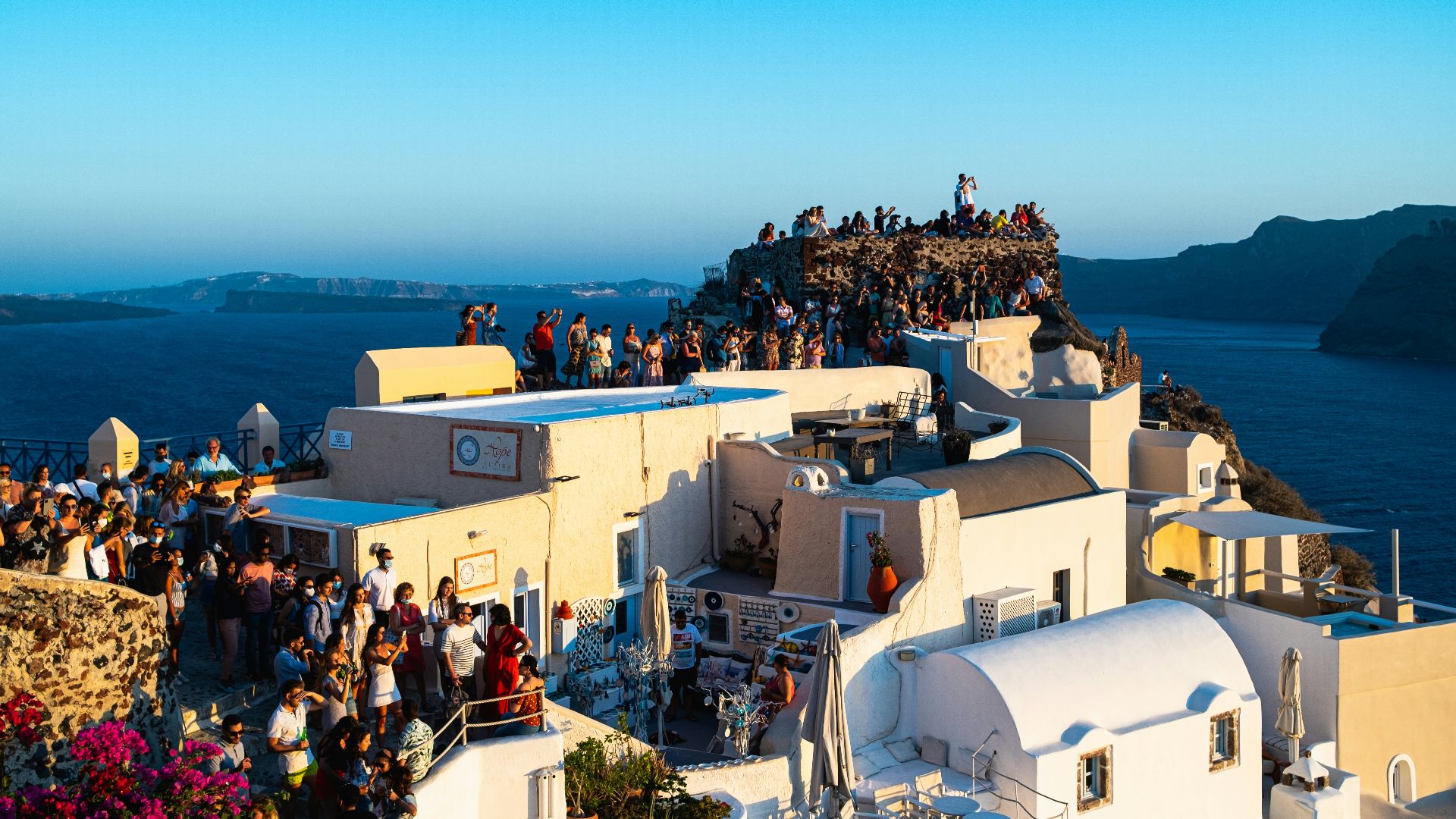 a group of people standing on top of a building