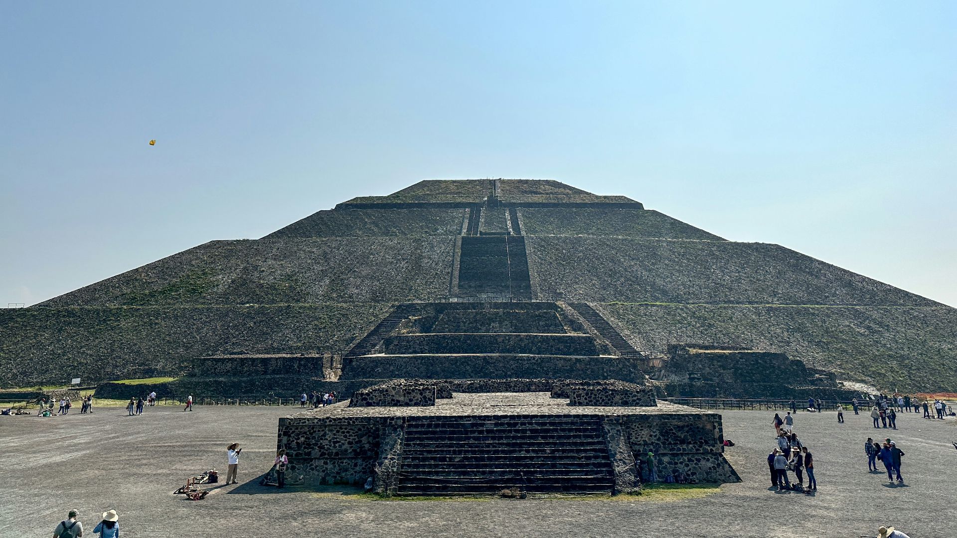 a large pyramid with people around it