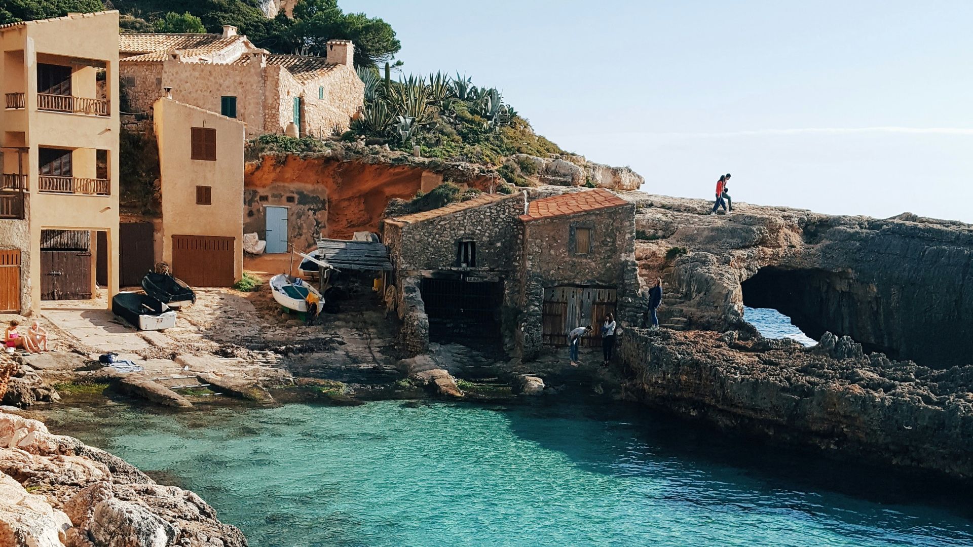 a body of water next to a rocky shore