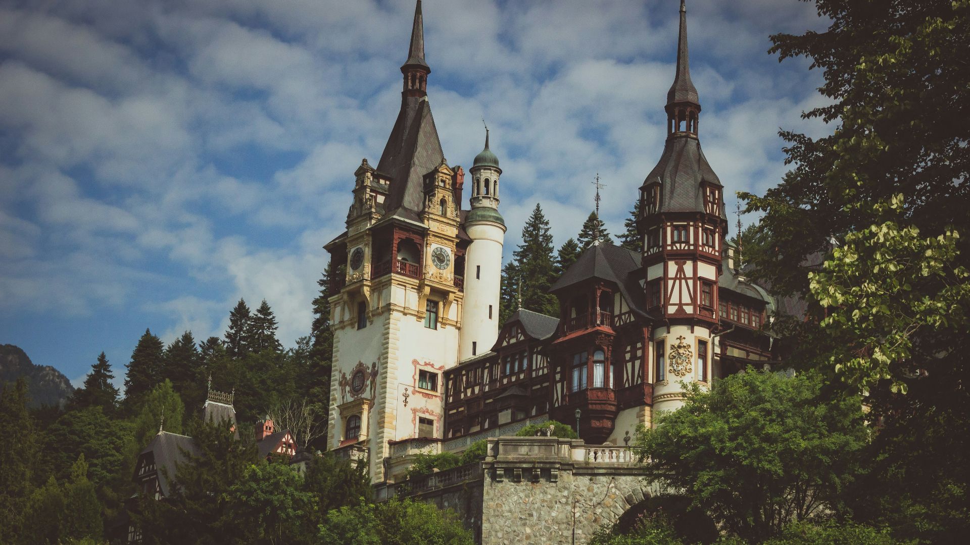 a large castle with two towers on top of a hill