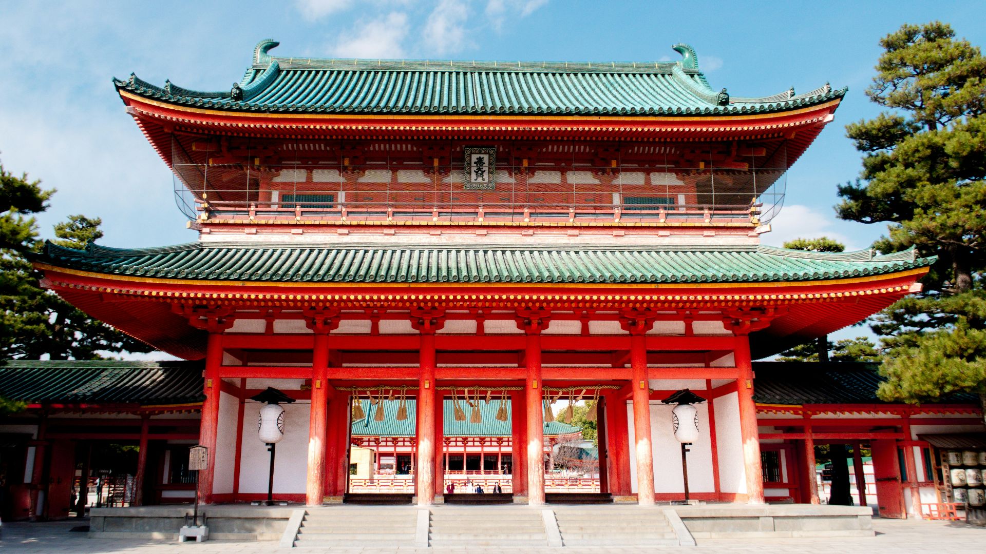 a tall red building with a green roof