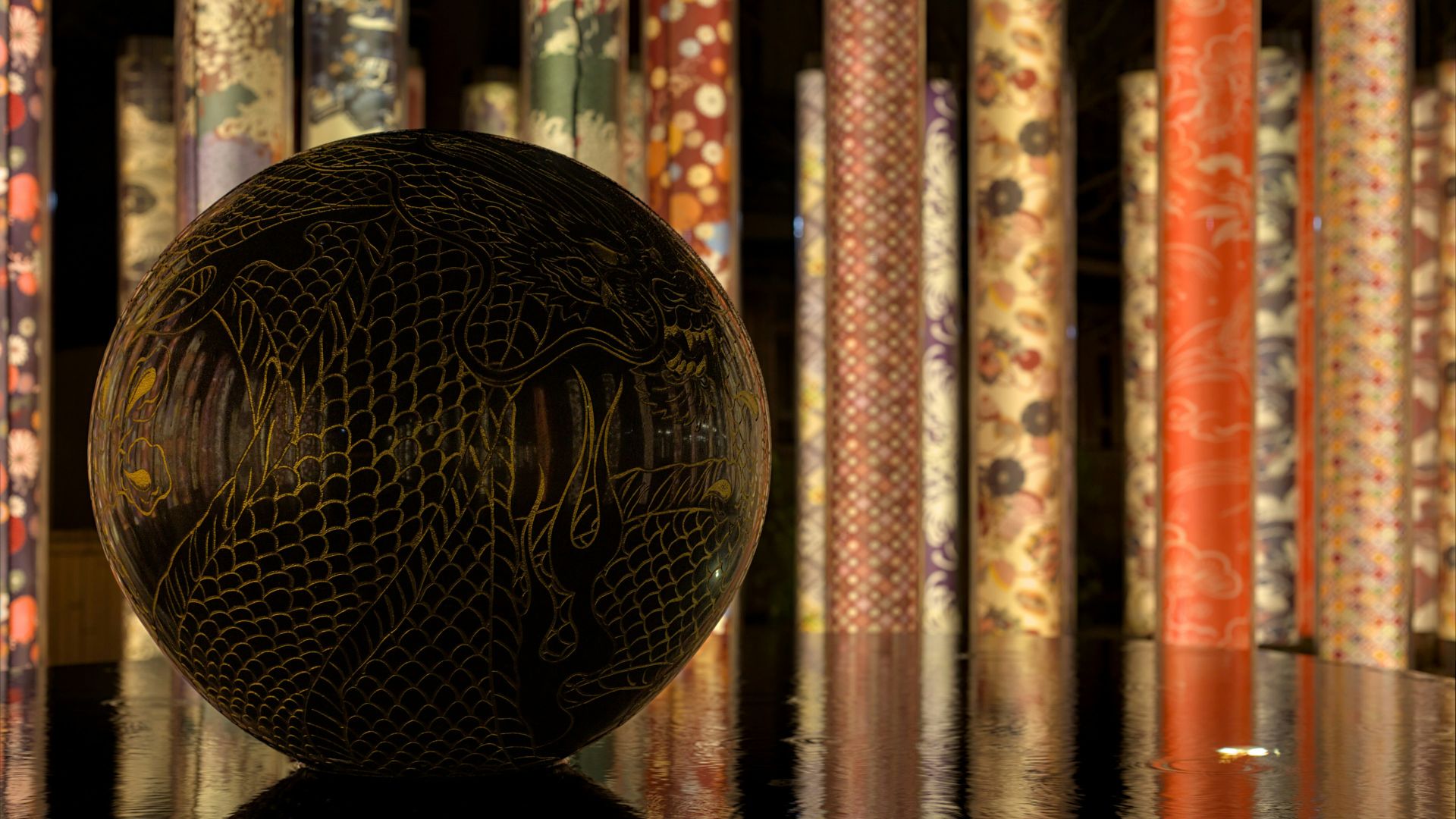 A ball sitting on top of a table in front of a wall of books