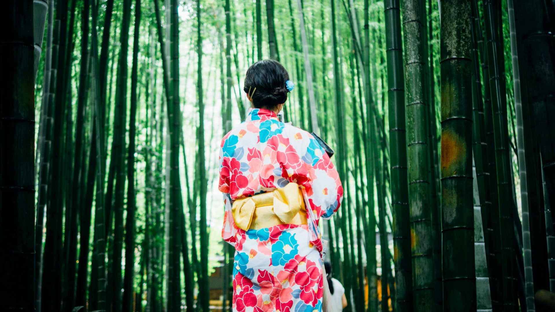 woman standing in front of trees