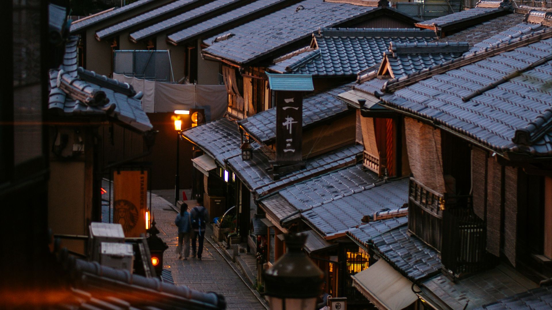 brown wooden houses near green trees during daytime
