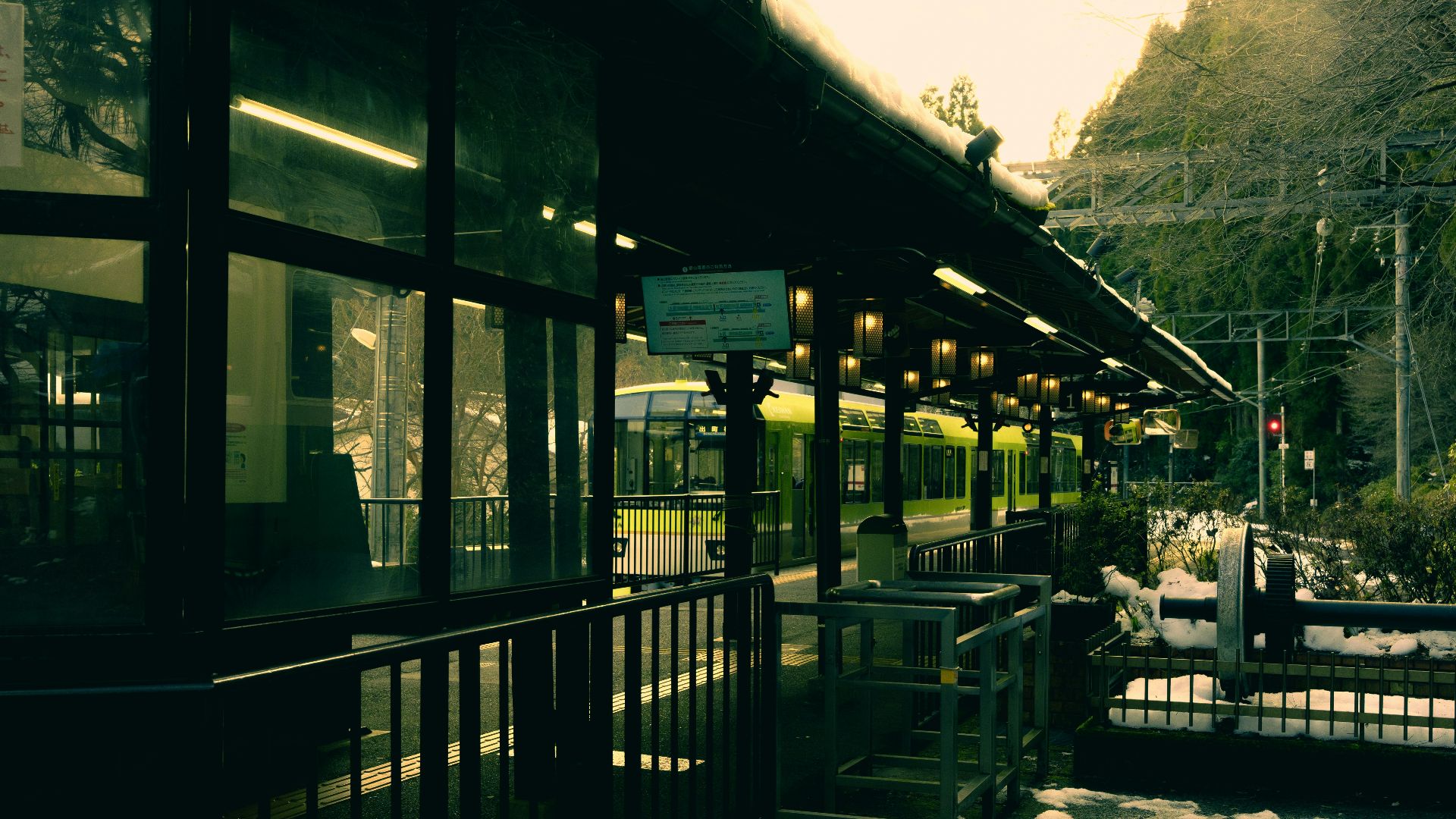 a train station with snow on the ground