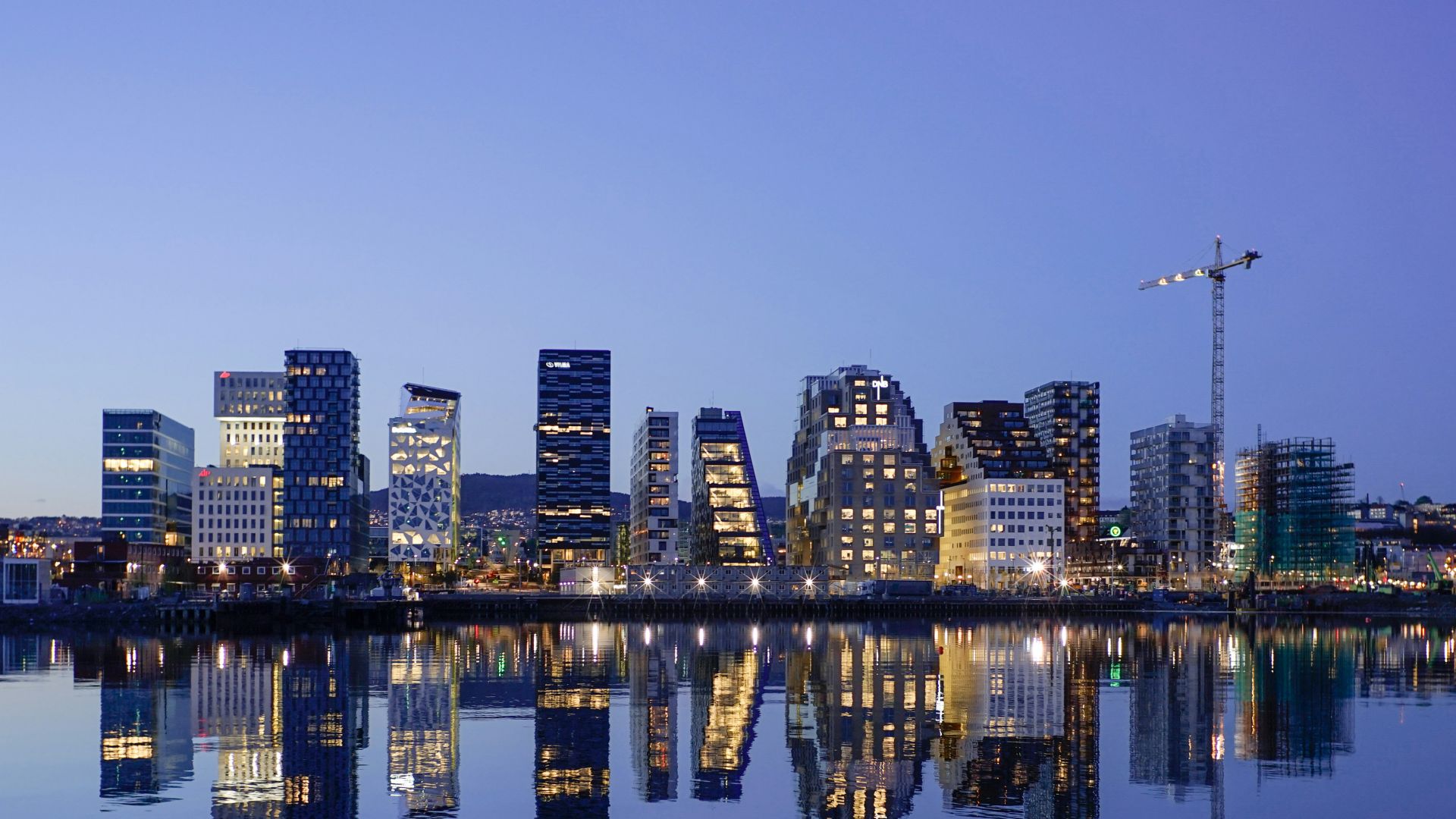 cityscape by water during golden hour