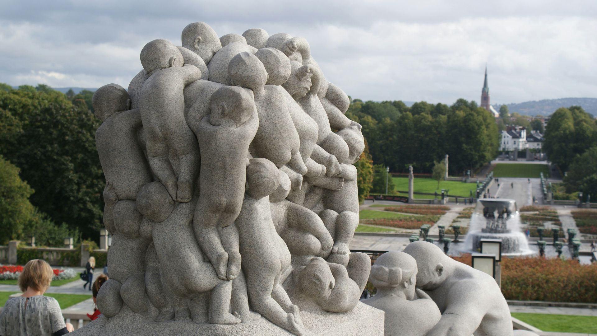 a group of people standing around a statue