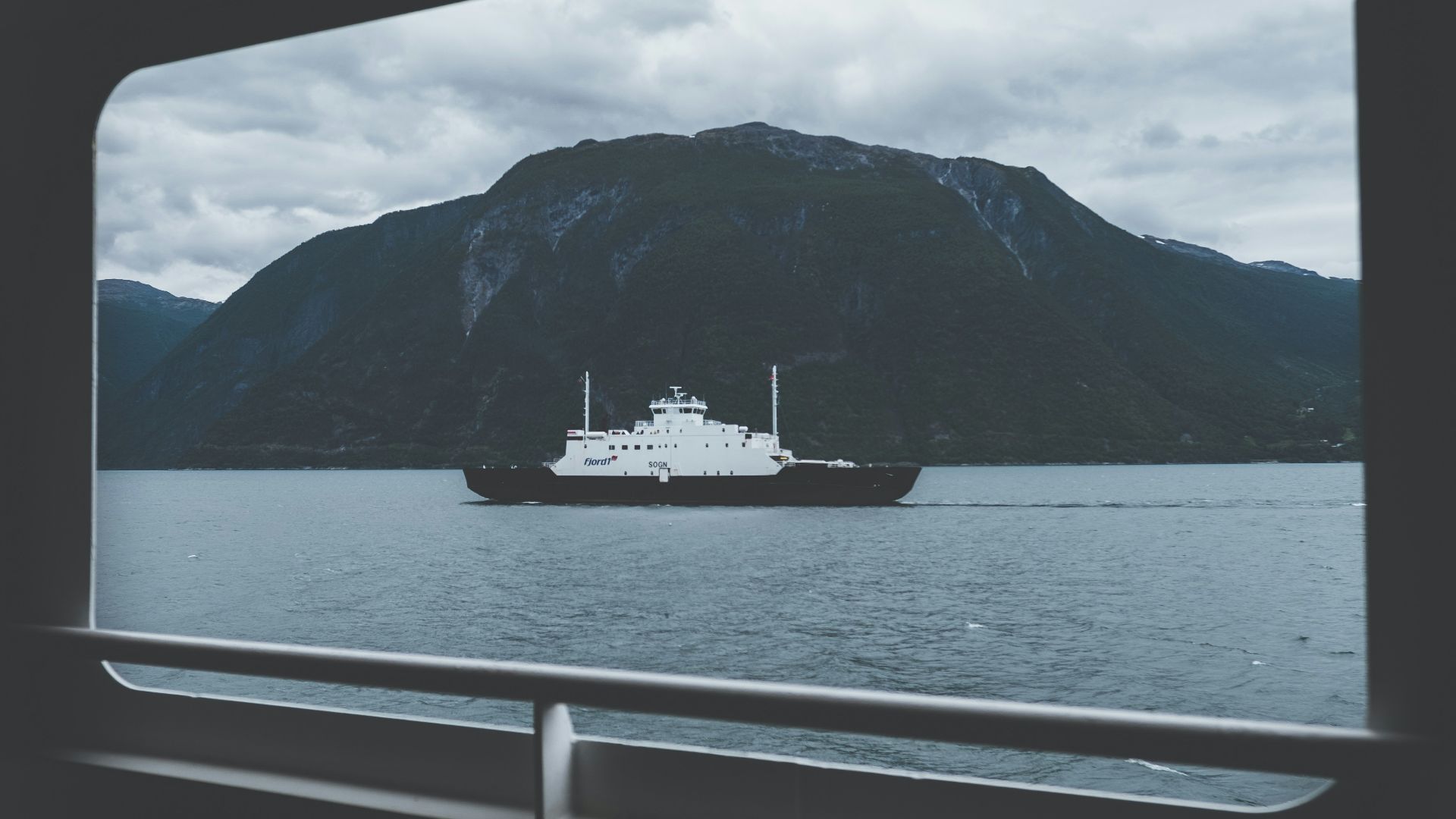 ship on body of water under gray sky during daytime