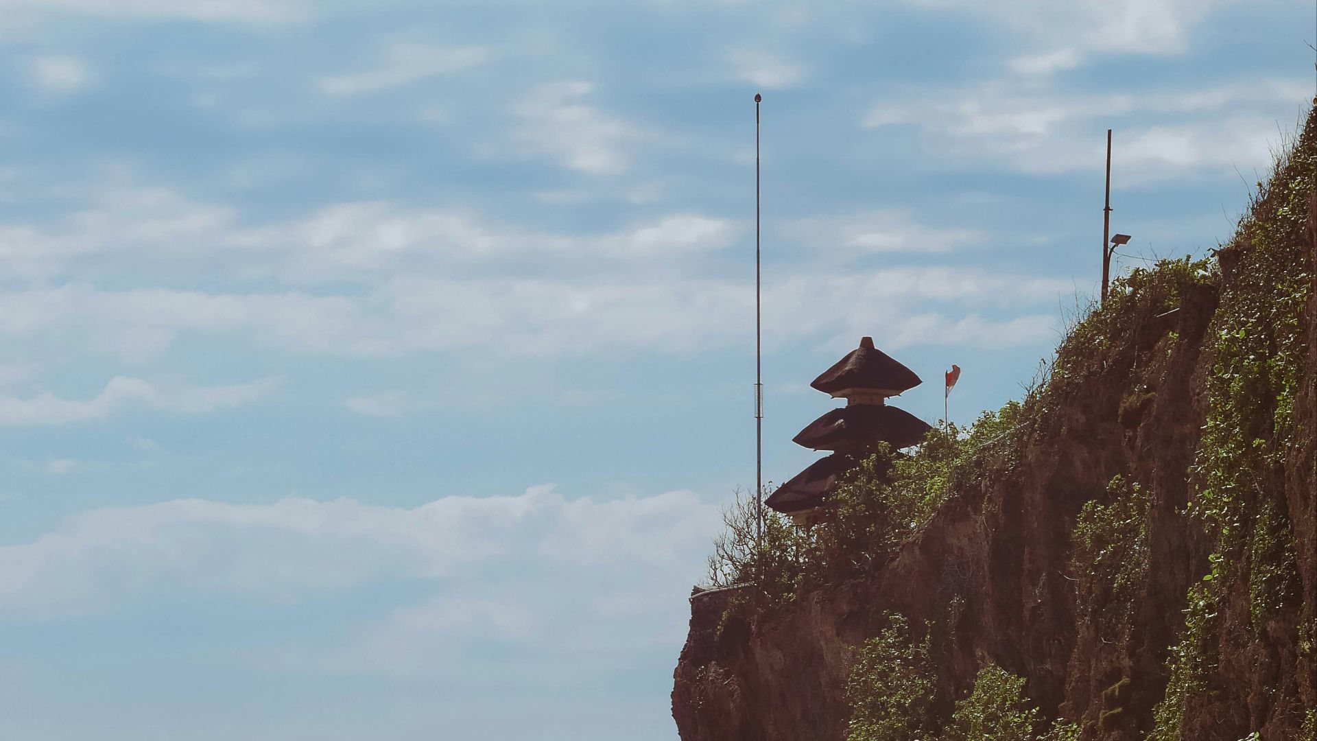 a cliff overlooking the ocean on a sunny day