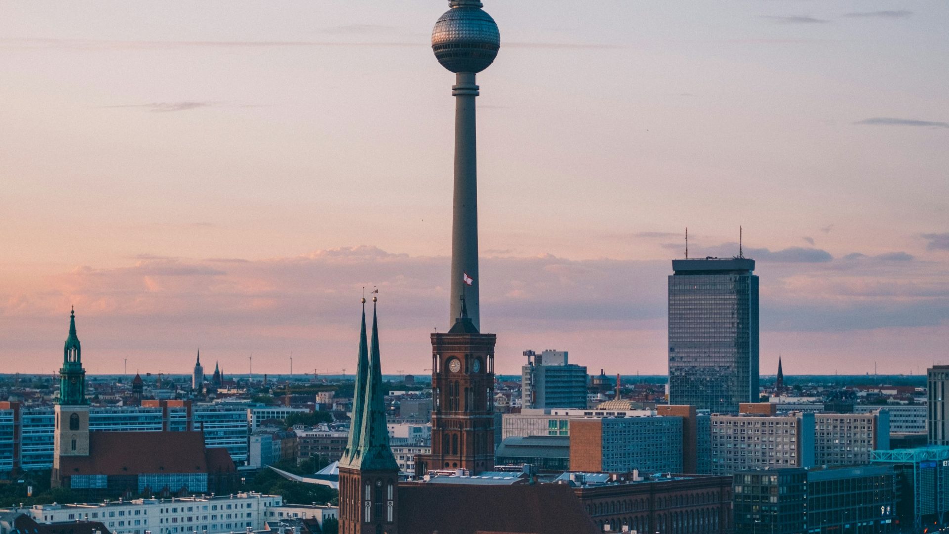 needle tower among small buildings