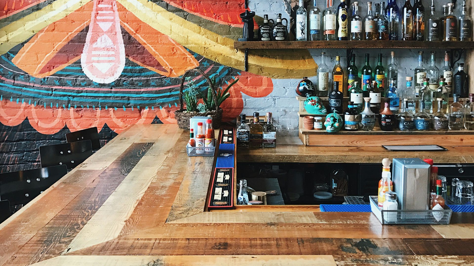 assorted bottles on wooden rack