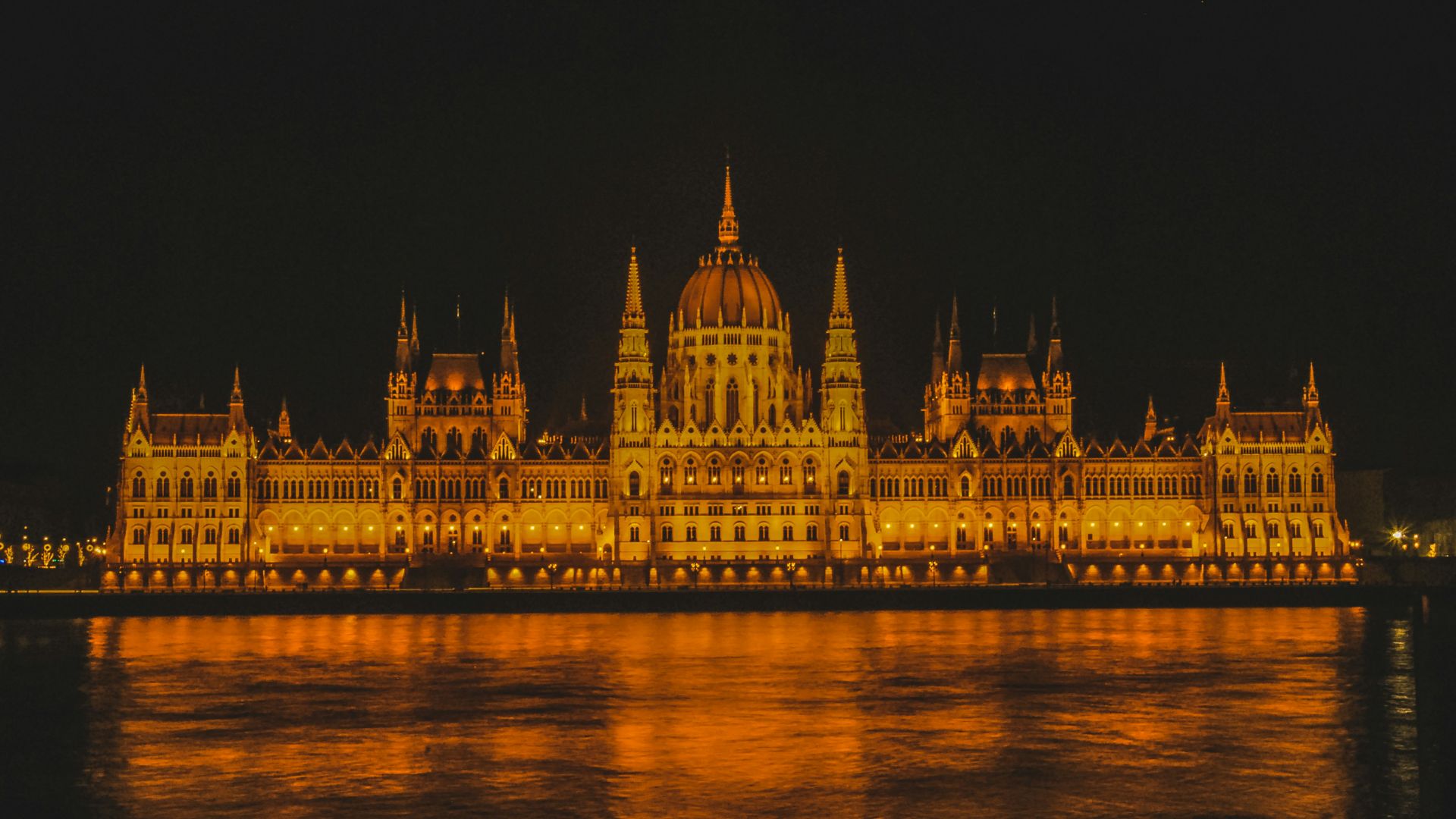 gray concrete building surrounded of body of water