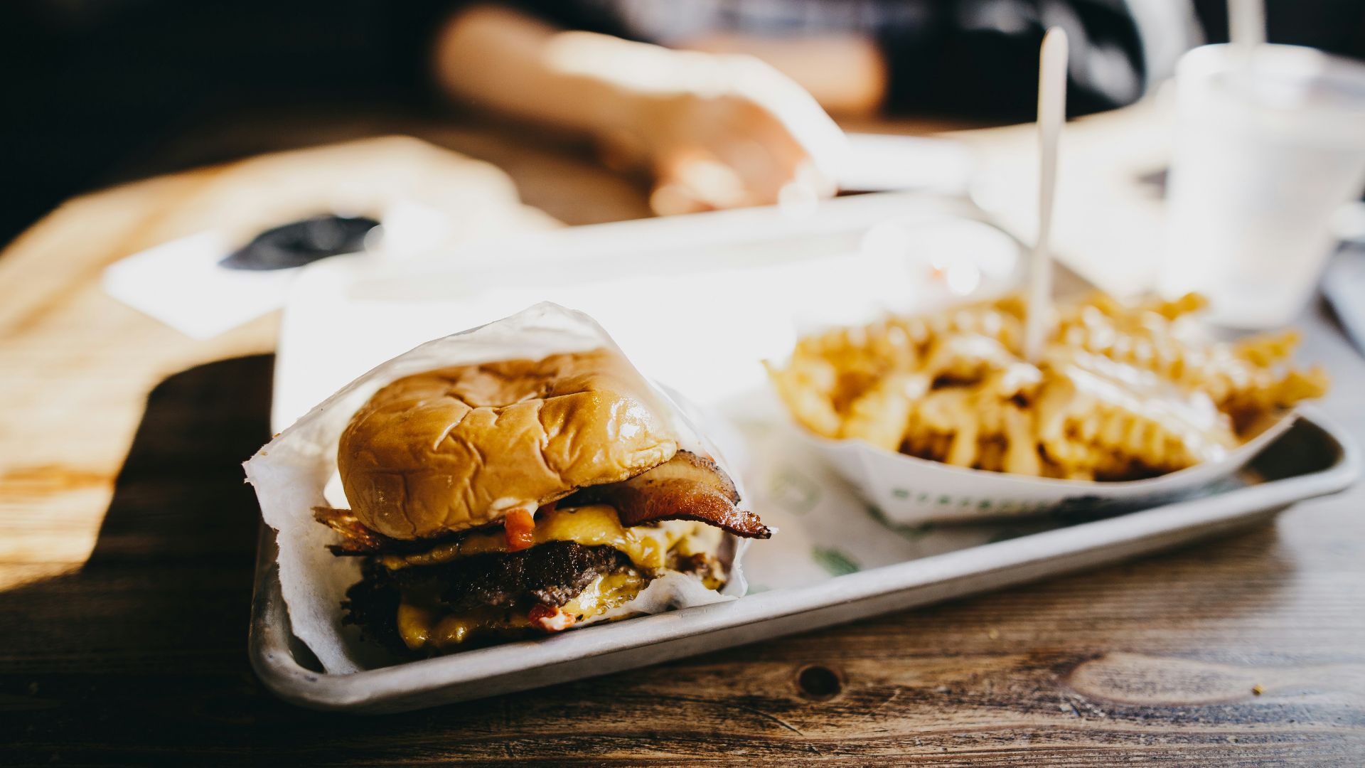 macro photography of burger and fries served on tray