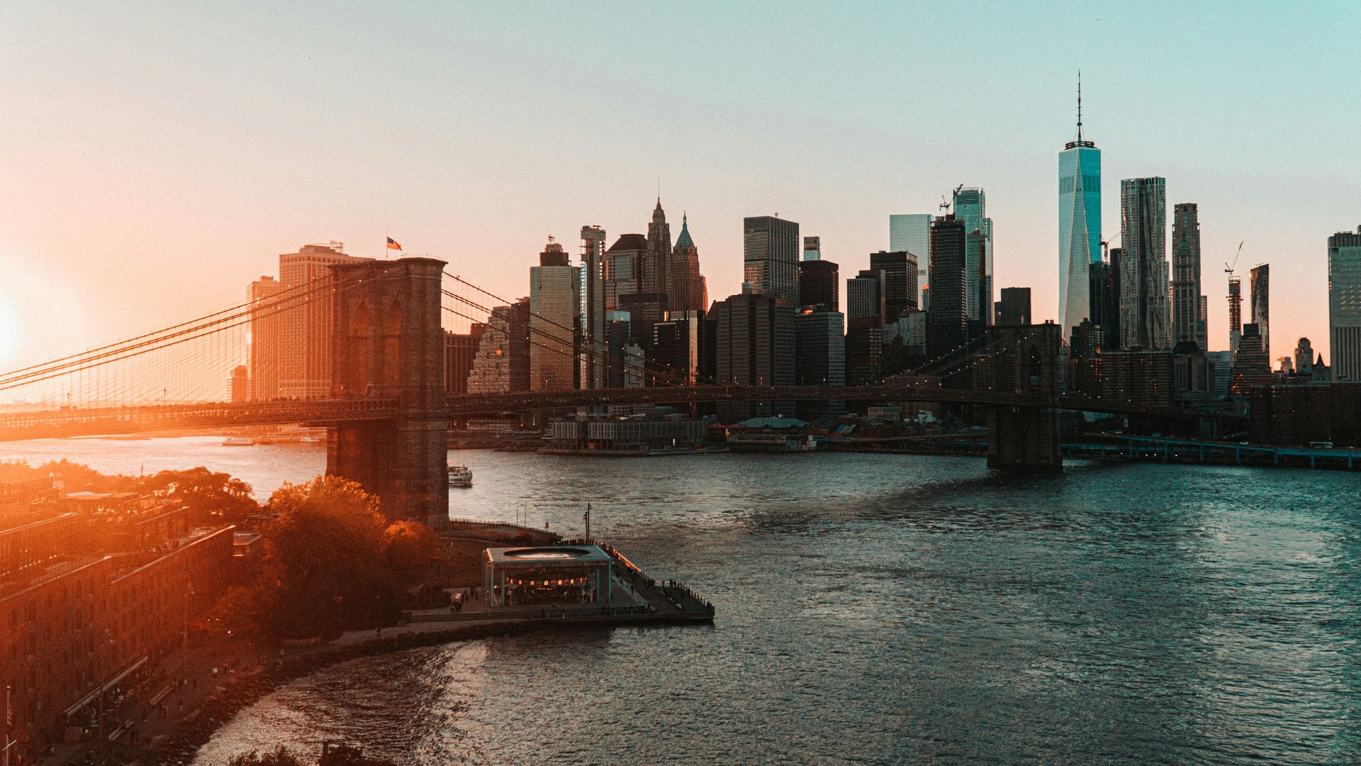 brown bridge over river near city buildings during daytime