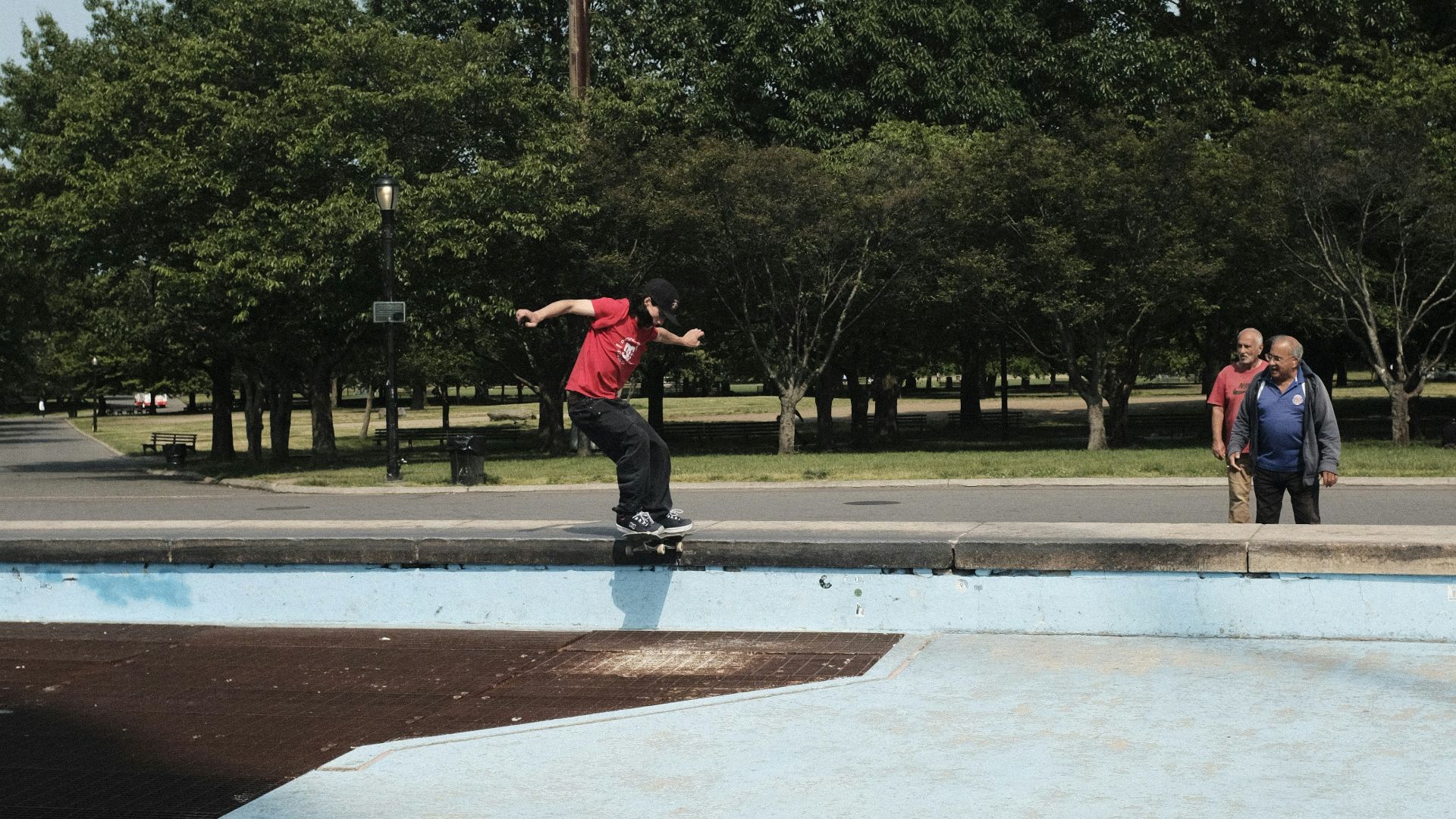 a man riding a skateboard on top of a blue ramp
