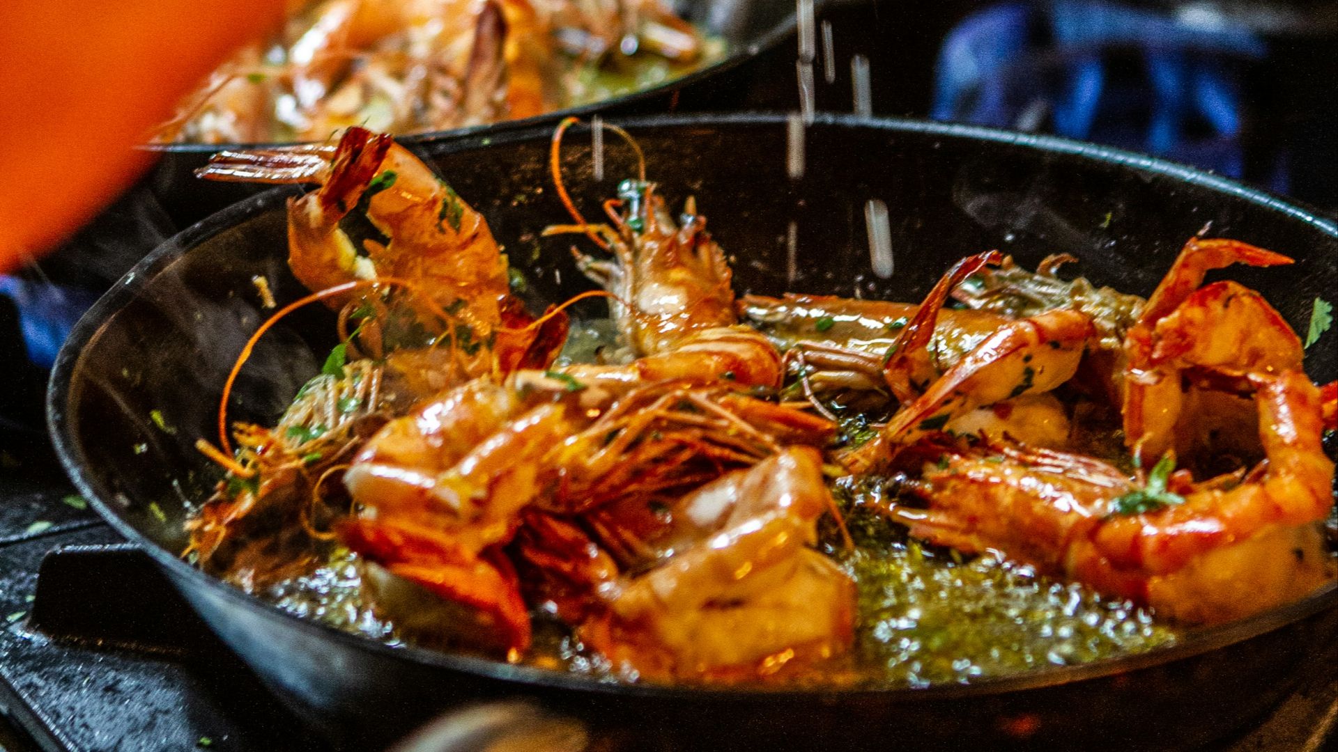 person holding stainless steel tray with cooked food