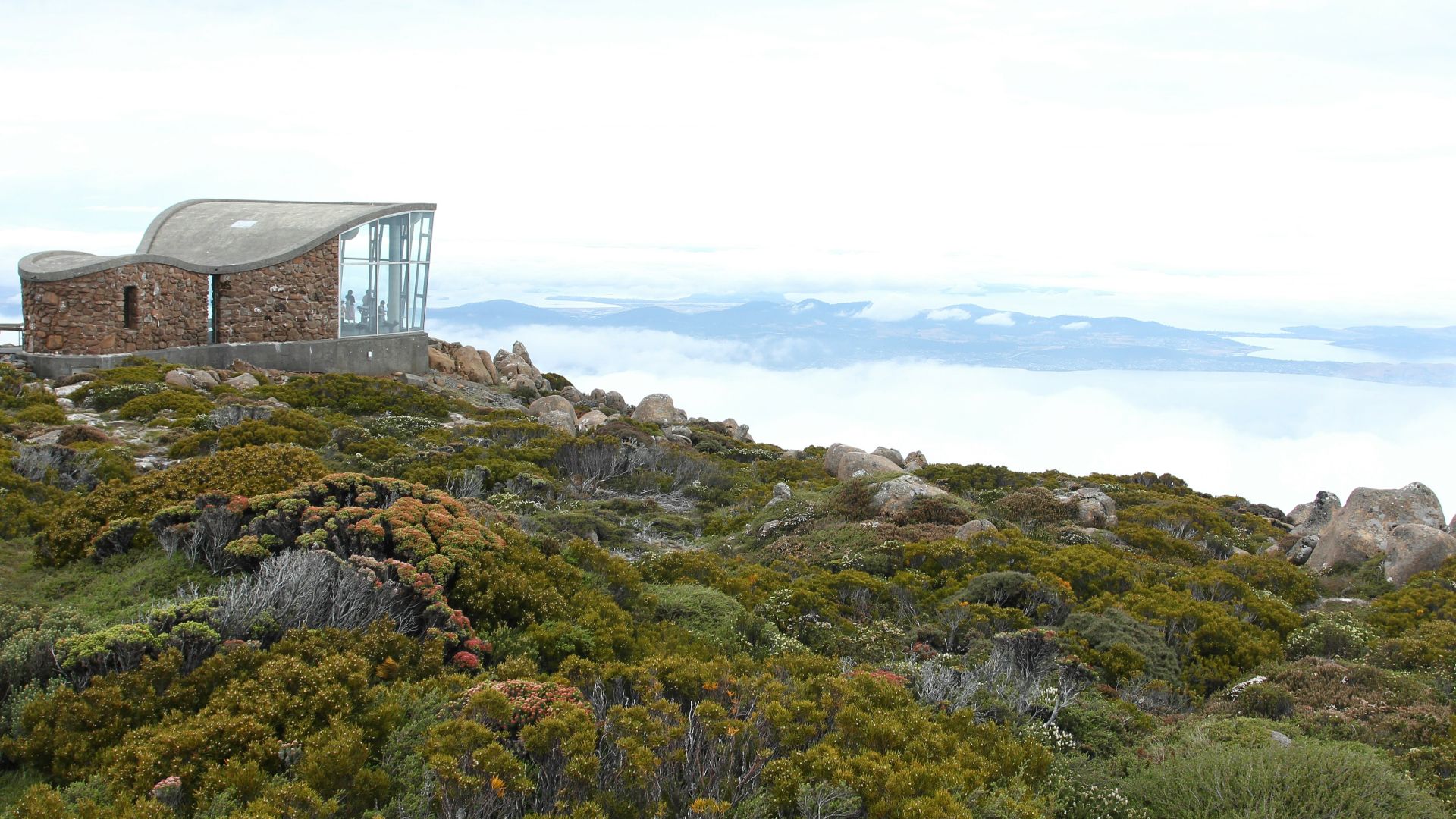 a building on top of a hill surrounded by trees