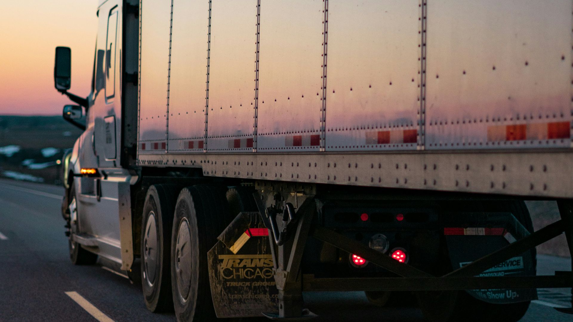 white freight truck on road during daytime