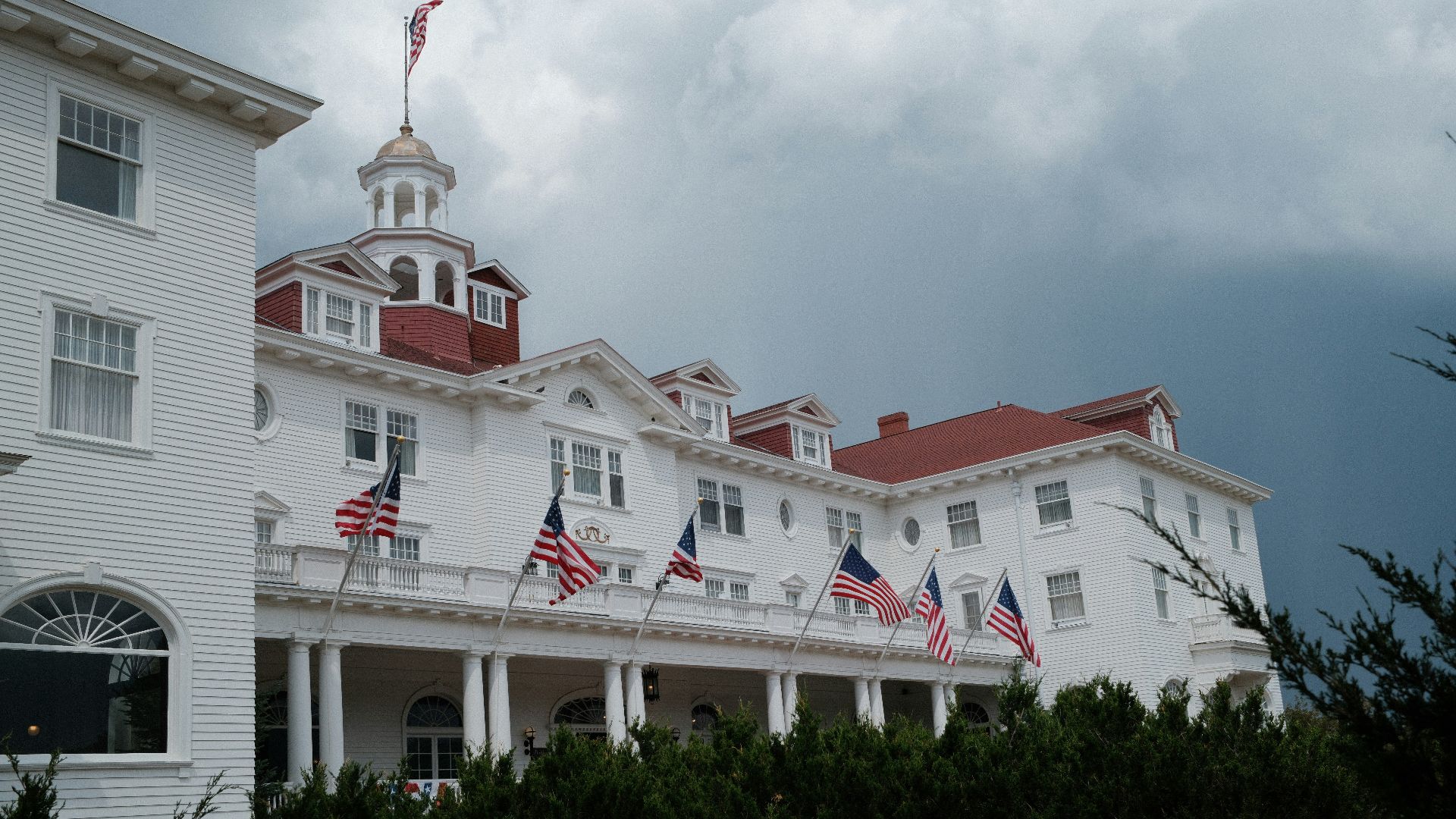 A large white building with a red roof