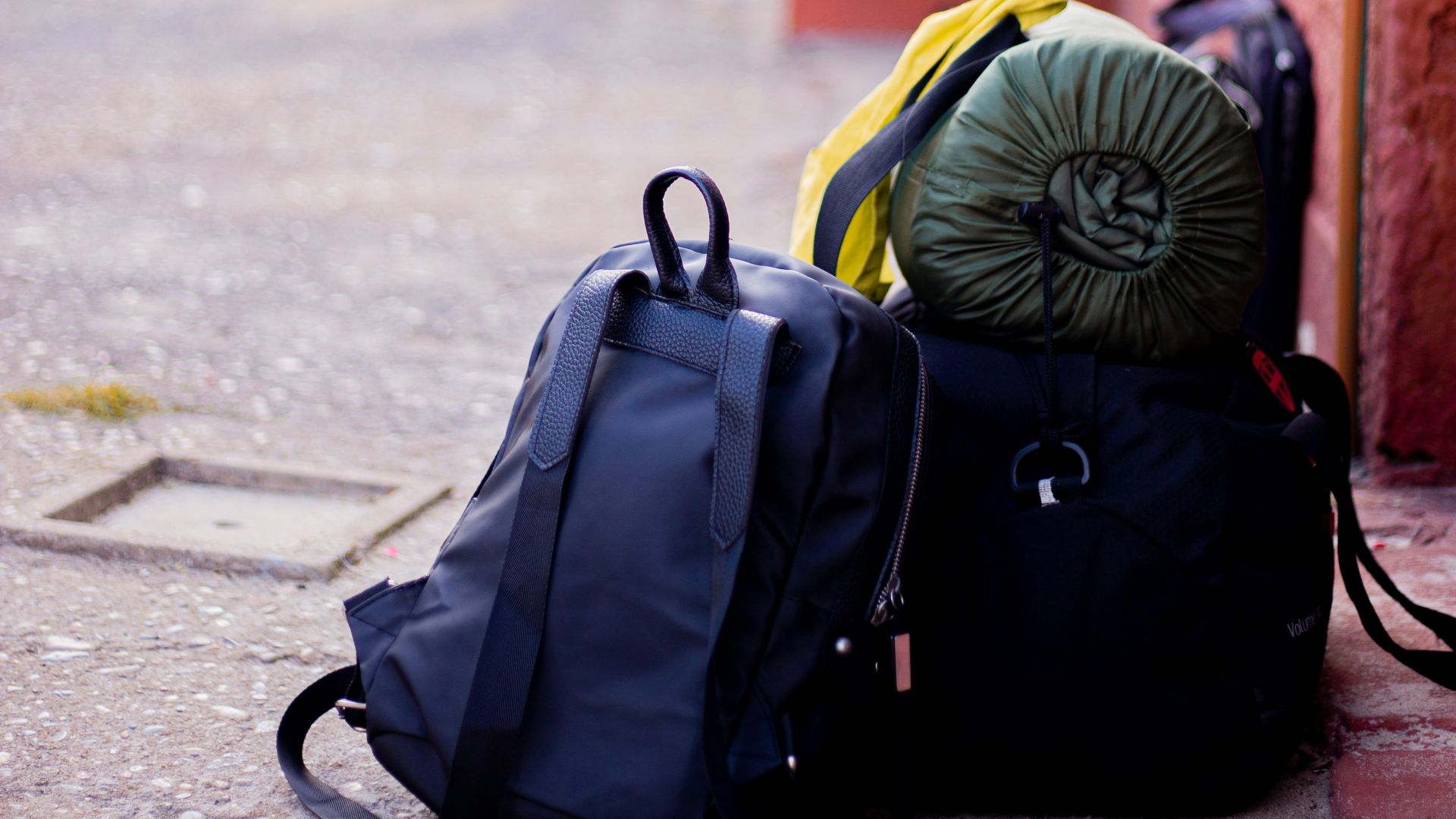 black backpack on gray concrete road