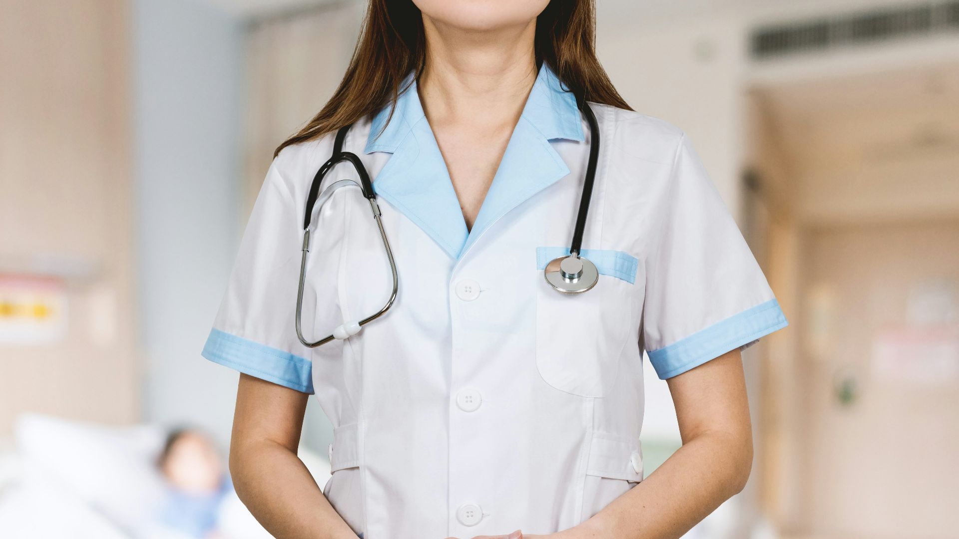 woman in white button up shirt and blue stethoscope