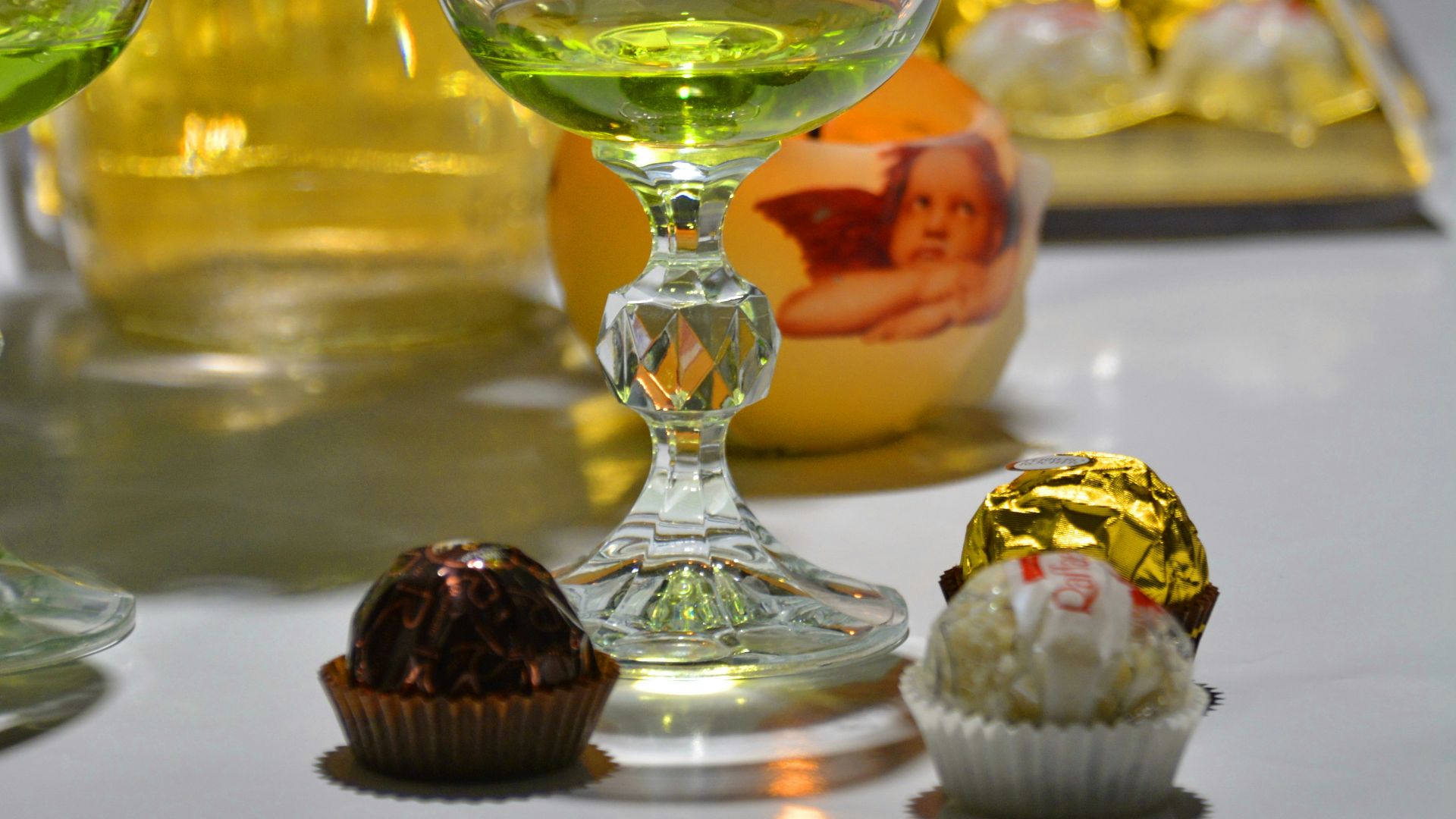 three clear wine glasses on white table