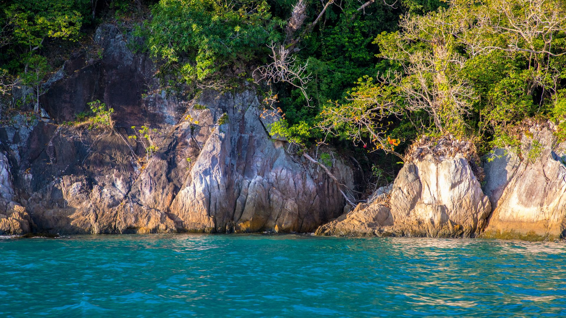 a large rock outcropping next to a body of water