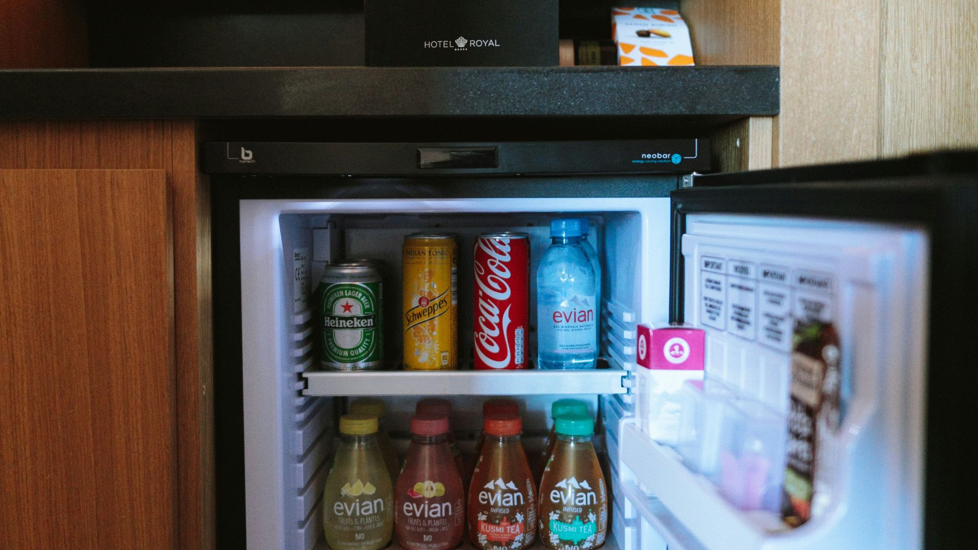 open black compact refrigerator filled with soda bottles