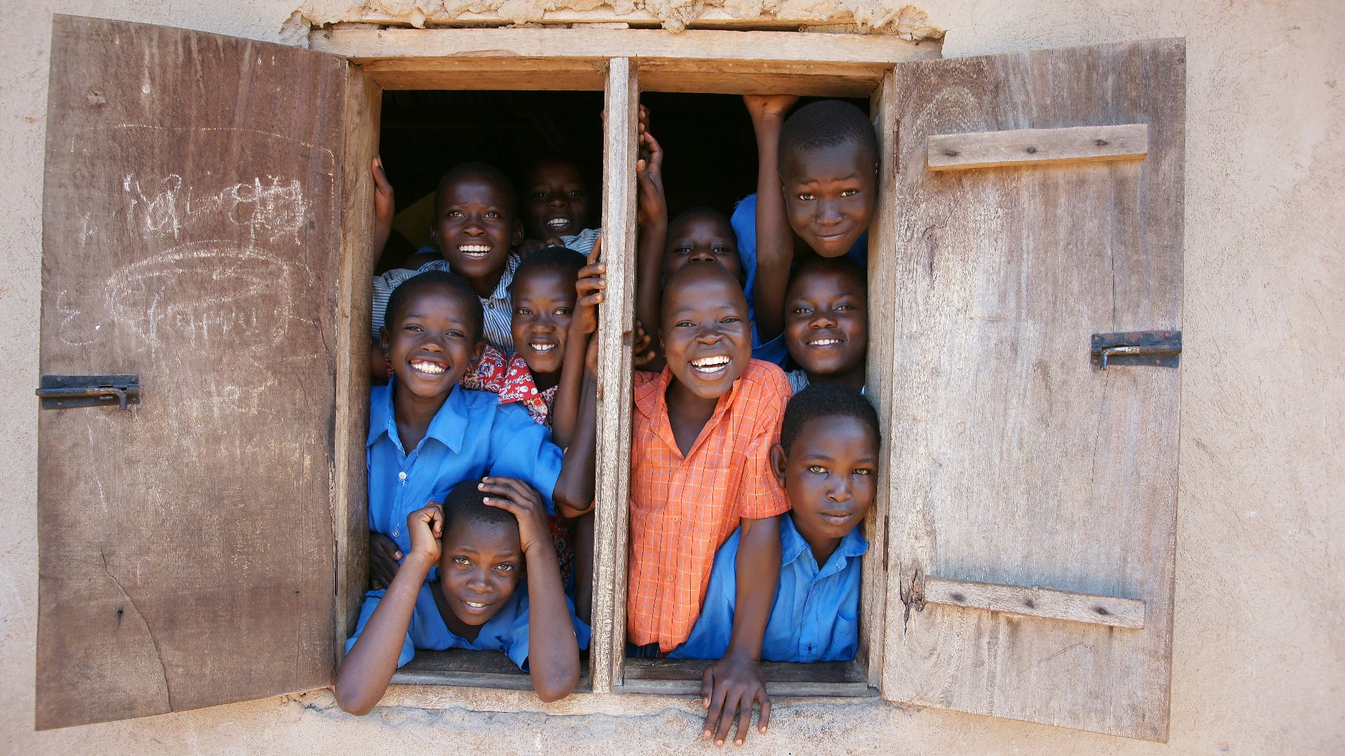 a group of young children standing in a window