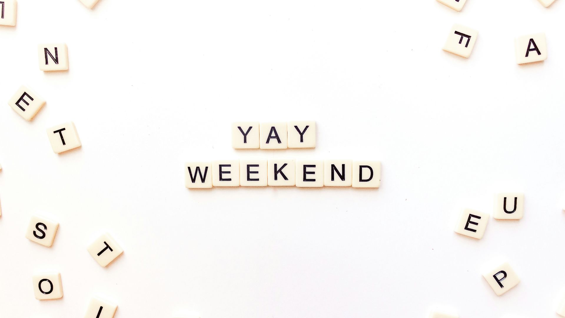 scrabble letters spelling out the word yay weekend