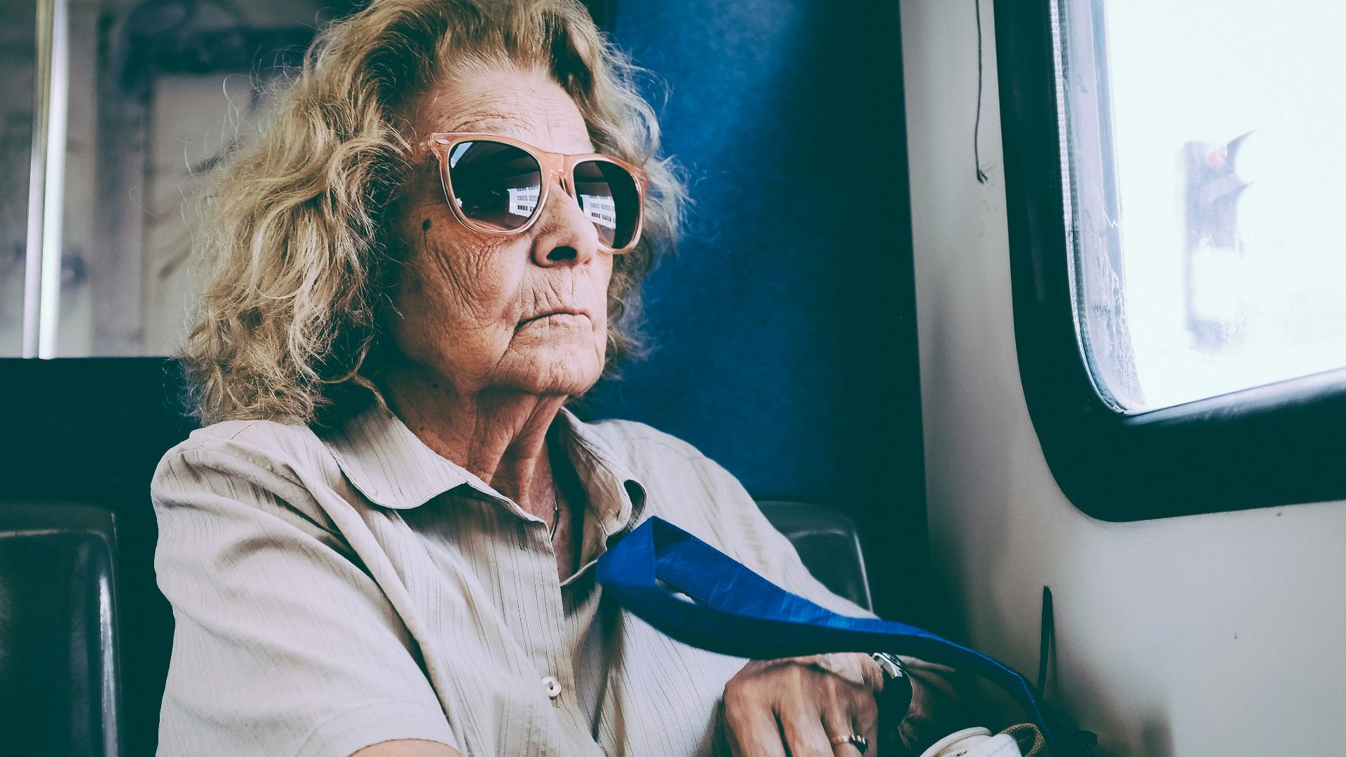 woman sitting on chair in front of window