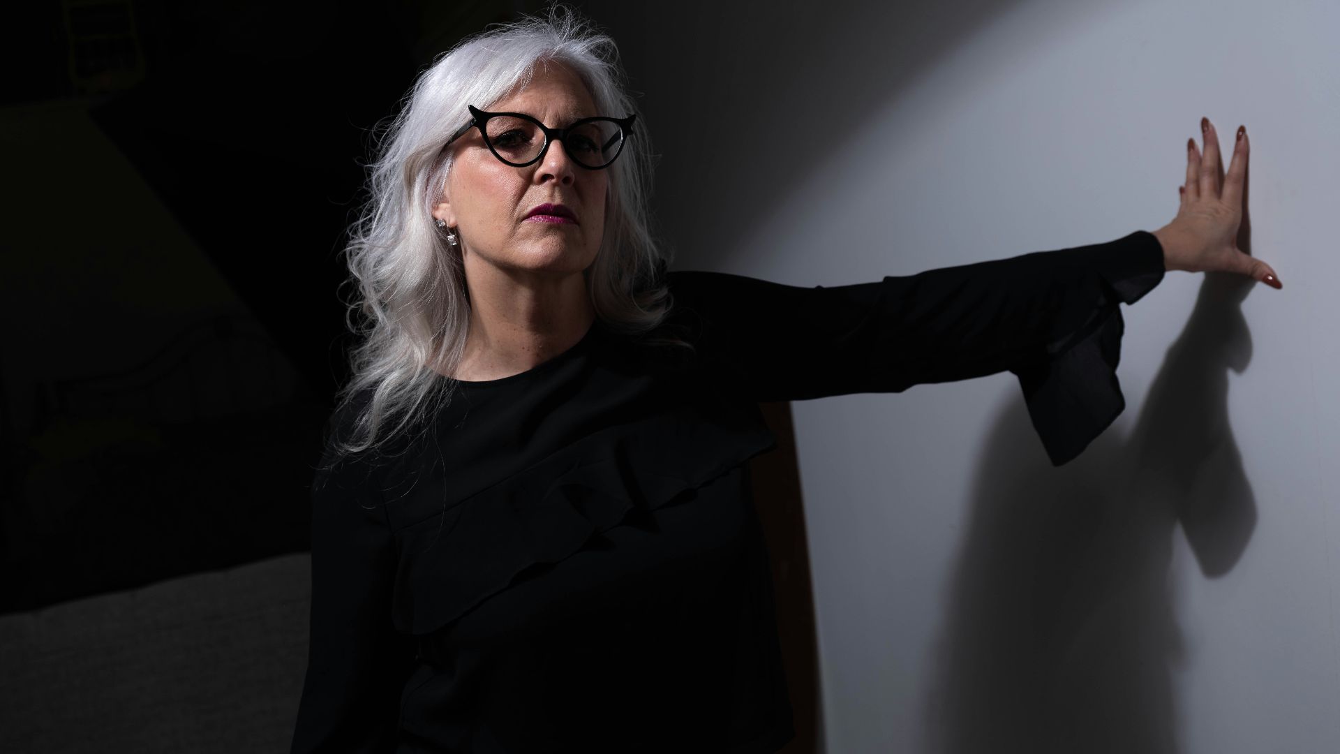 woman in black long sleeve shirt wearing eyeglasses