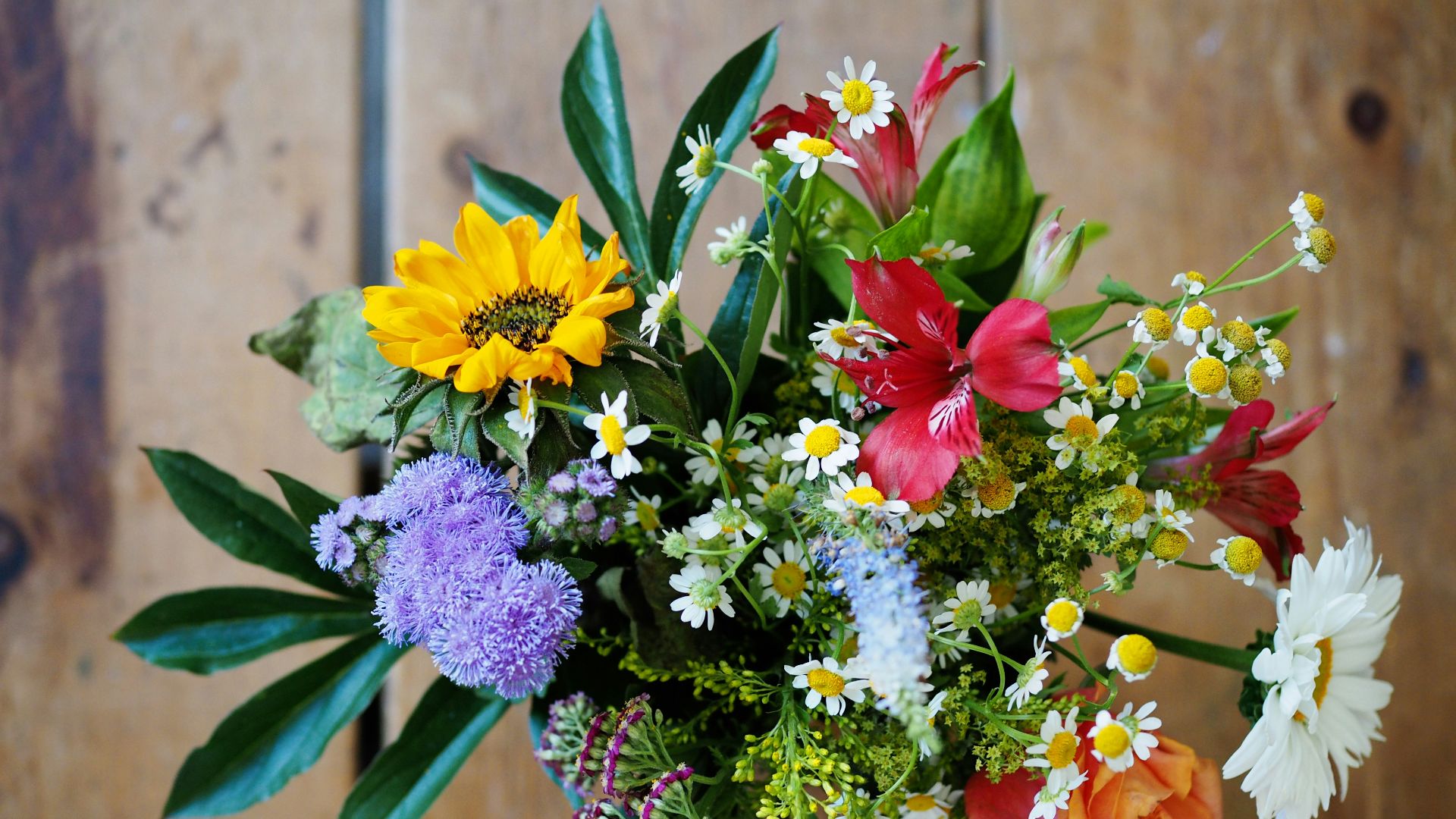 assorted-color flowers on brown wood