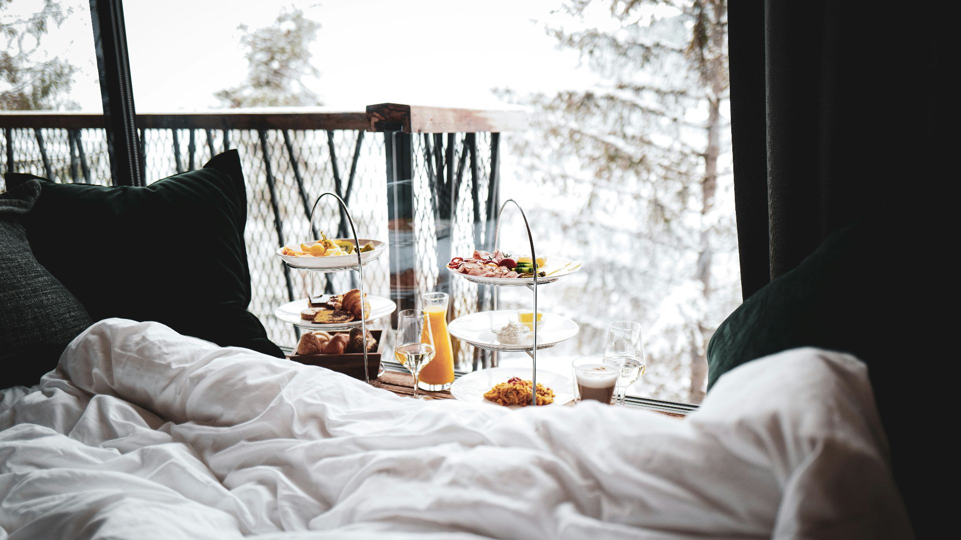 a bed with a tray of food on top of it