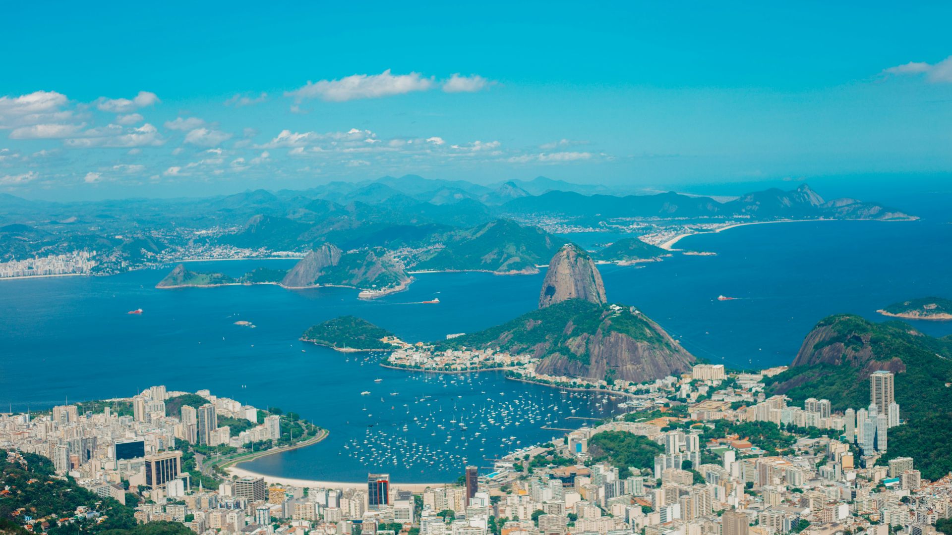 aerial photography of buildings near blue sea and mountains