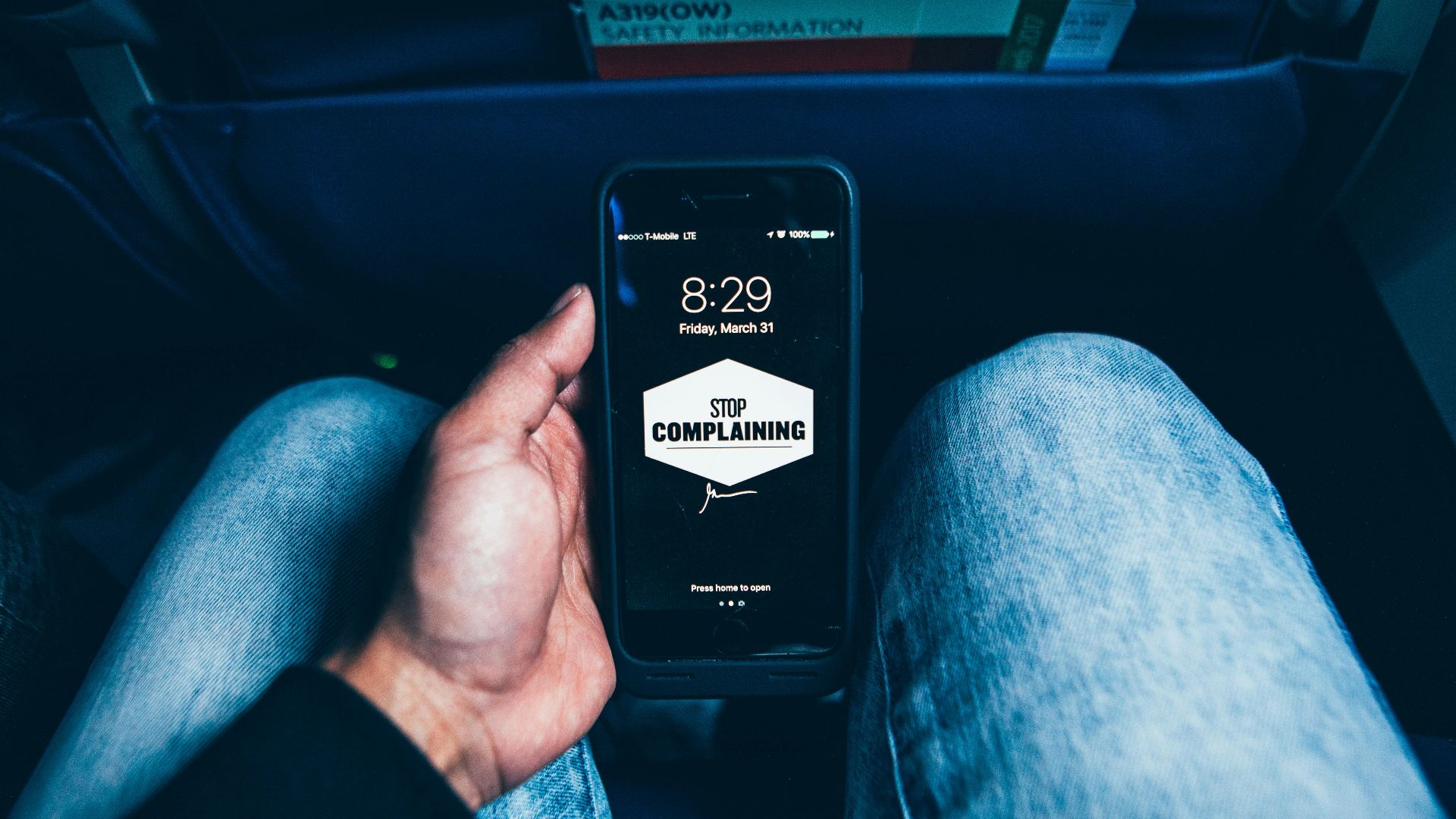person holding phone displaying stop complaining text screengrab