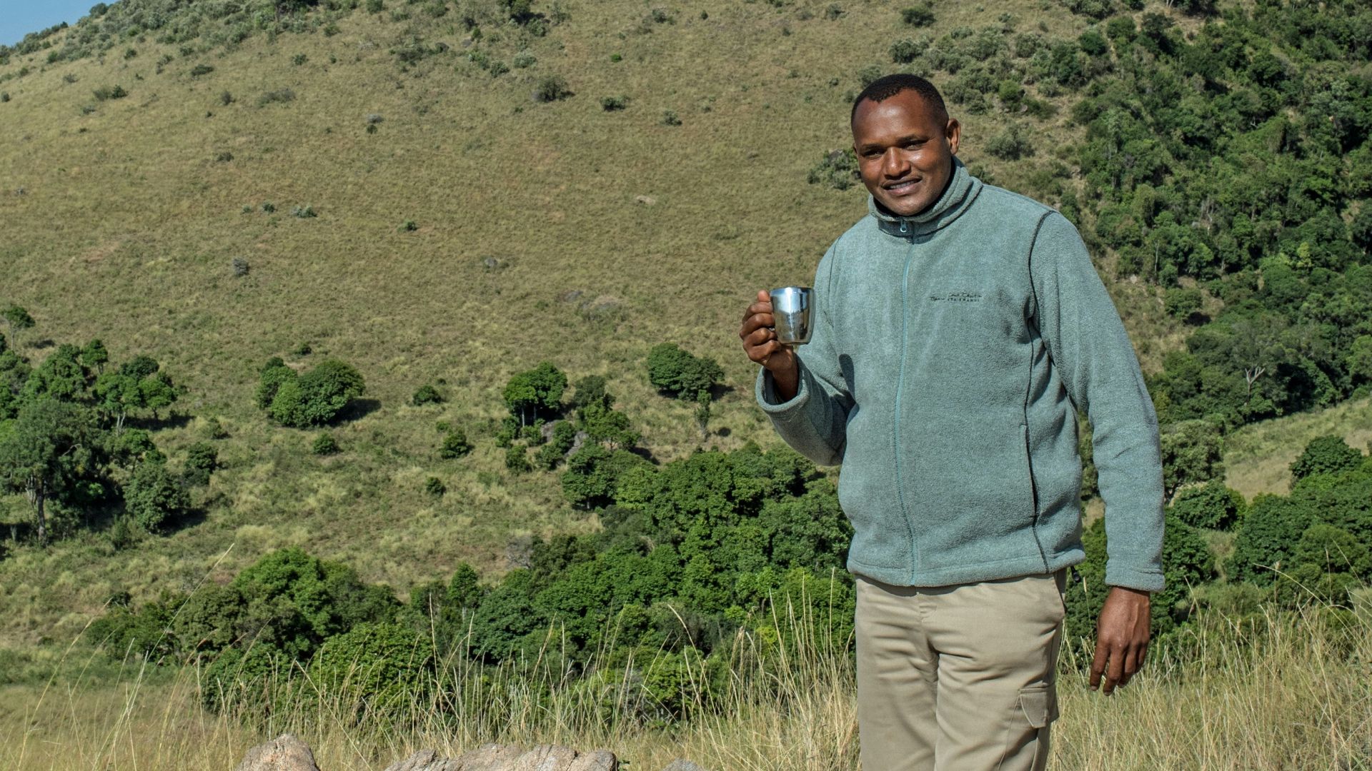 man standing on green field