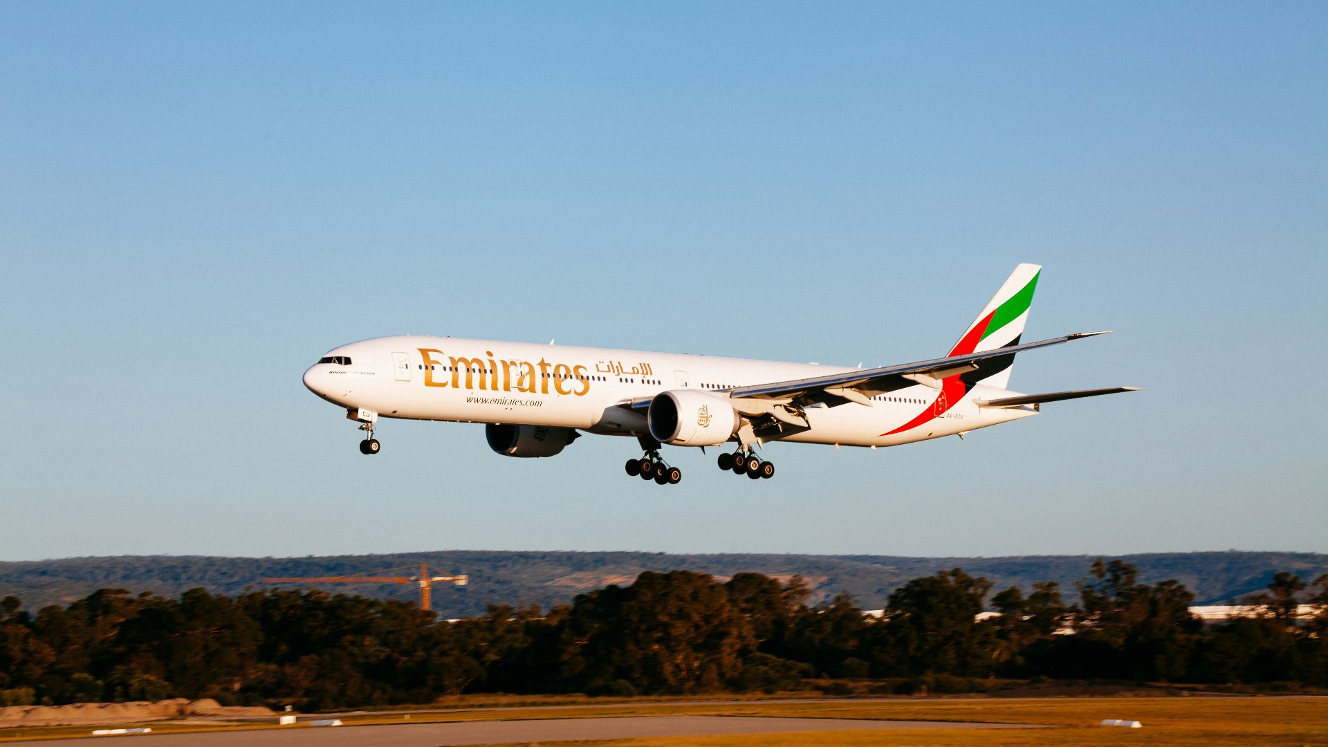 white and red passenger plane in the sky during daytime