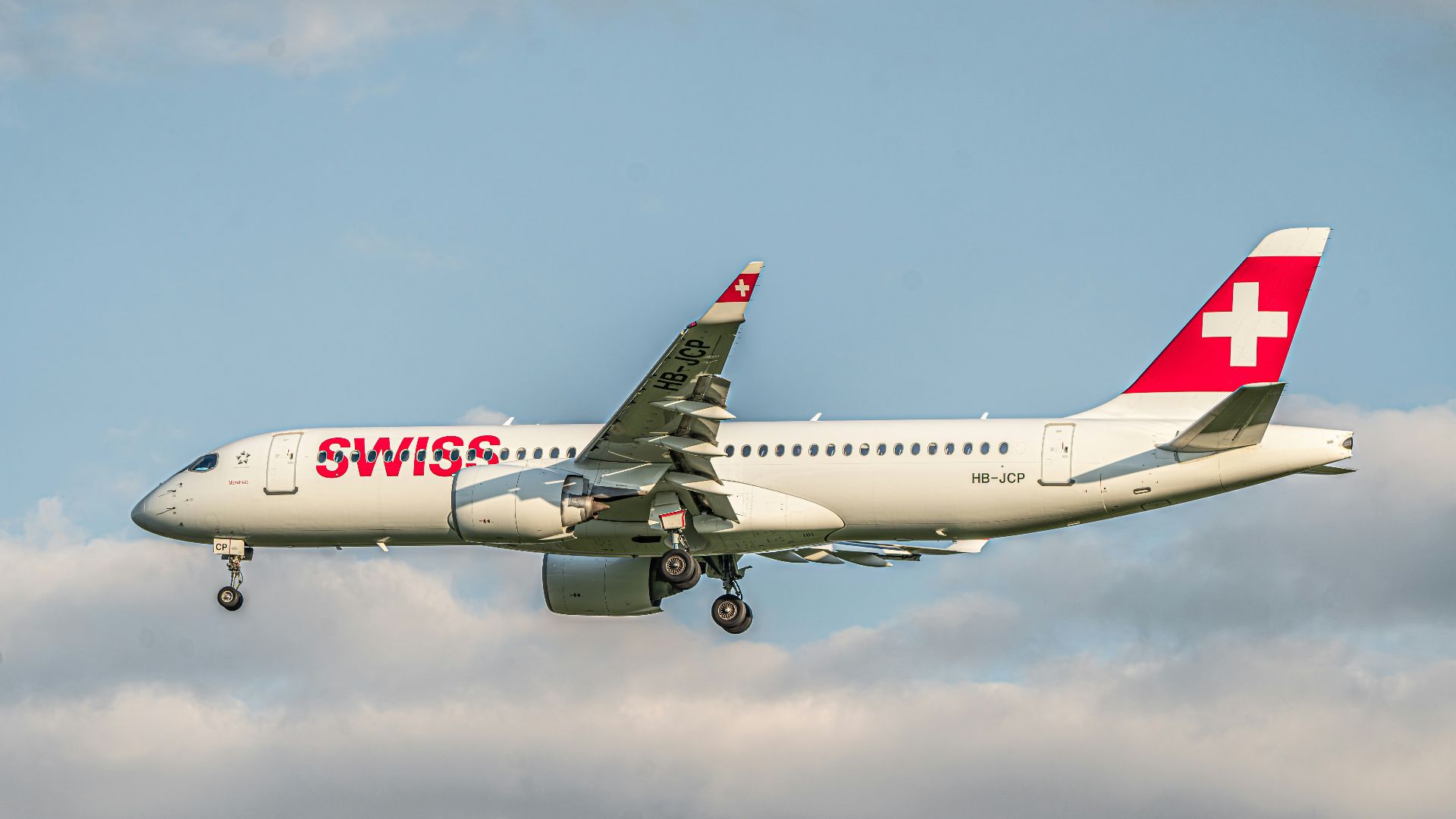 a large passenger jet flying through a cloudy sky