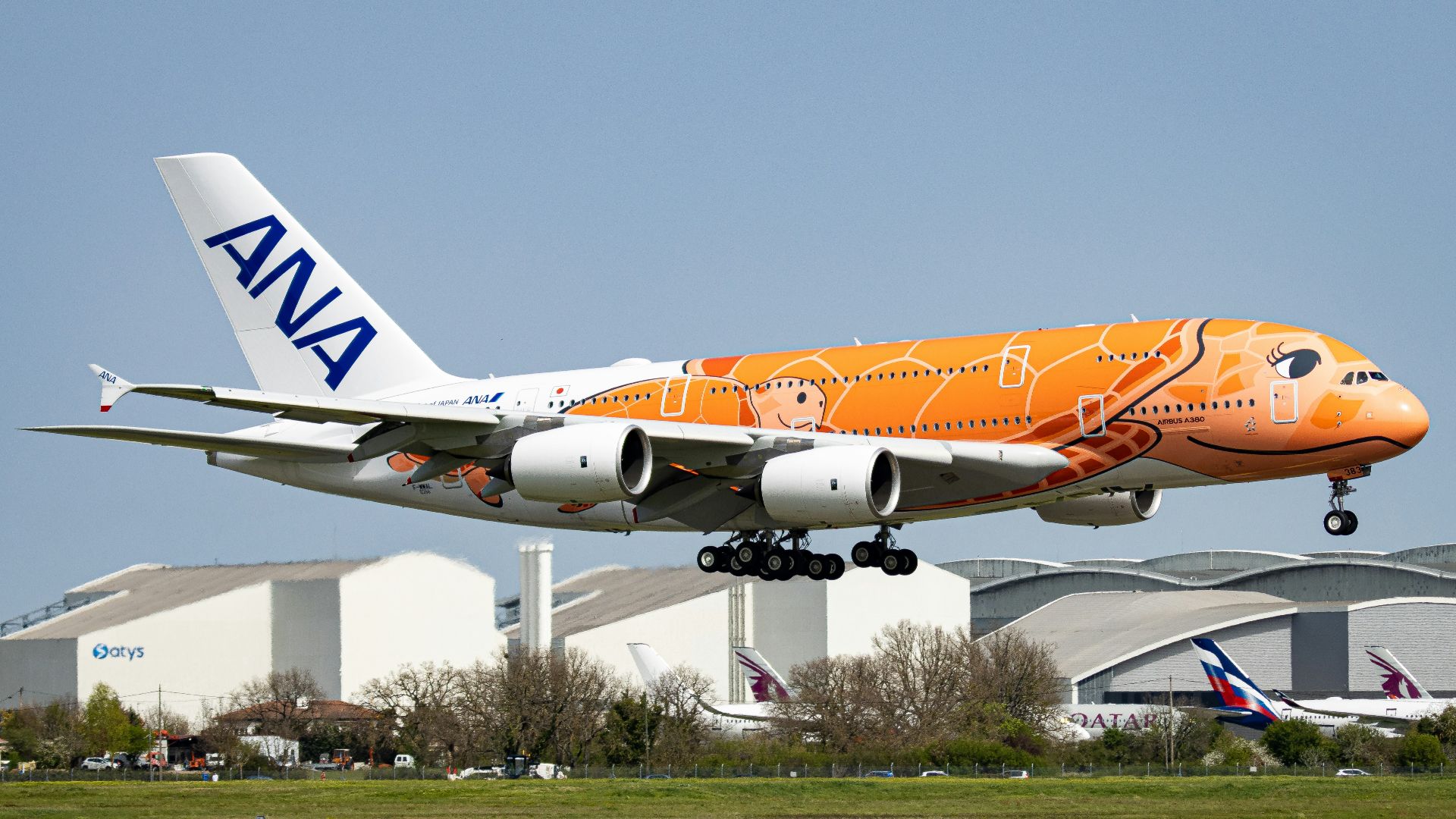 orange and white passenger plane on airport during daytime